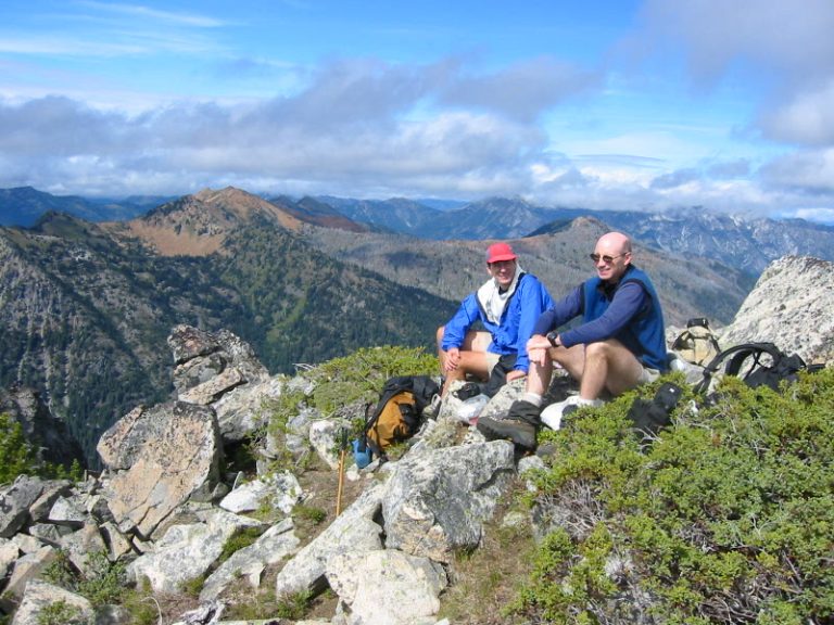 Two climbers sit on the summit of Harding Mountain in the Upper Icicle Mountains
