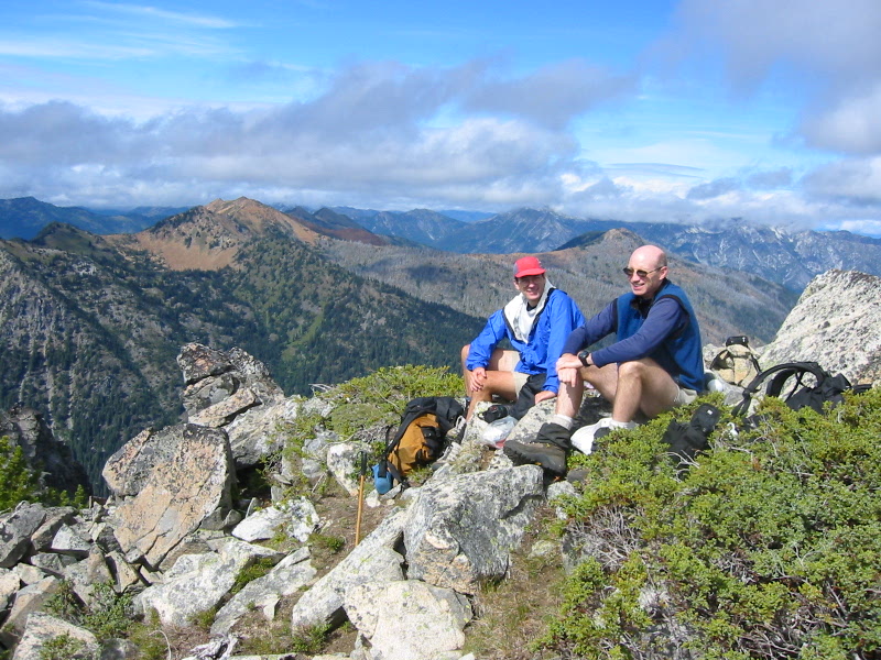 Two climbers sit on the summit of Harding Mountain in the Upper Icicle Mountains