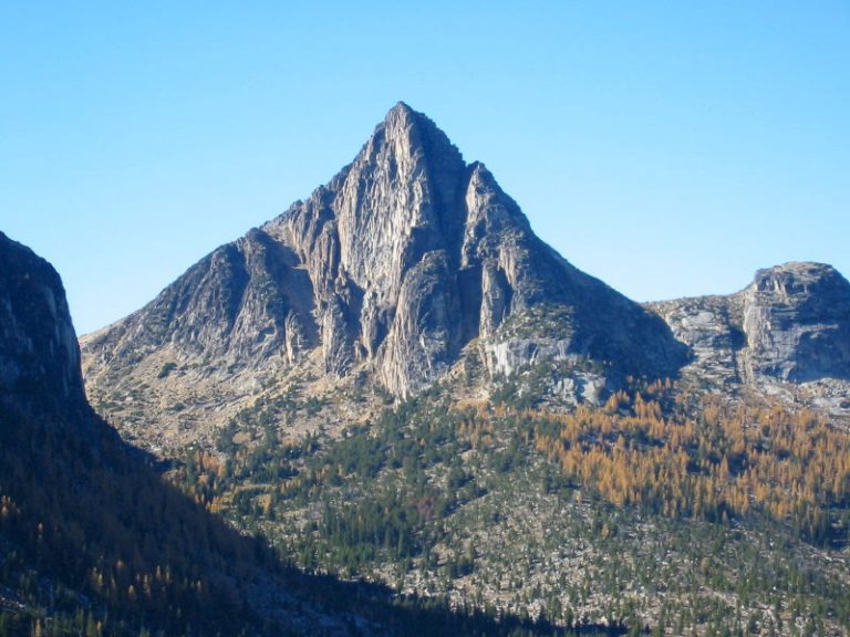 The sharp granite pyramid of Cathedral Peak towers over a forested plain in the Similkameen Mountains as seen from Apex Pass on the Cathedral Lakes Loop hiking trip