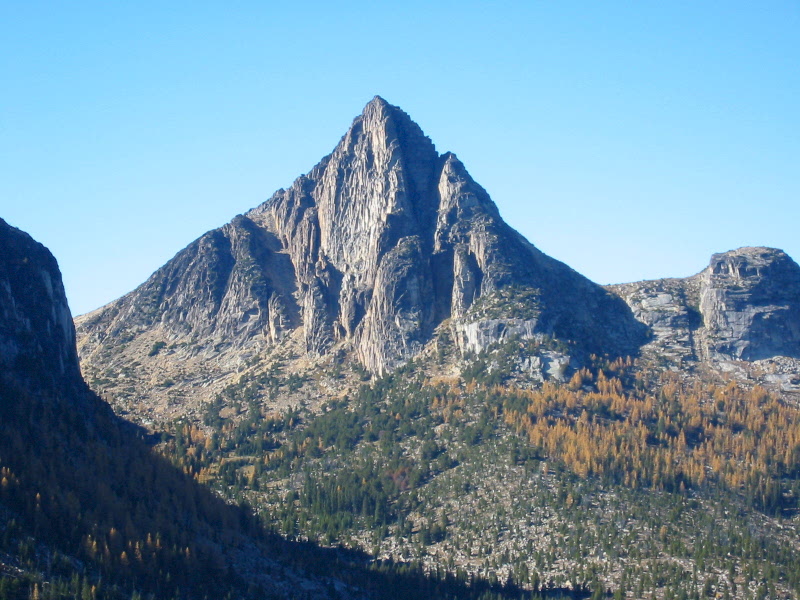 The sharp granite pyramid of Cathedral Peak towers over a forested plain in the Similkameen Mountains as seen from Apex Pass on the Cathedral Lakes Loop hiking trip