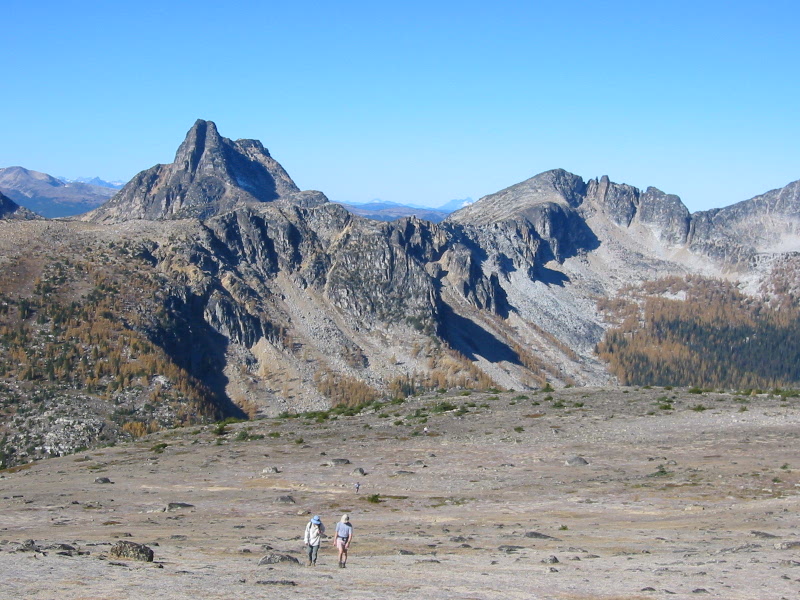 mountain climbers hiking across mountain plains with Cathedral Peak in the Similkameen Mountains in the Pasayten Wilderness