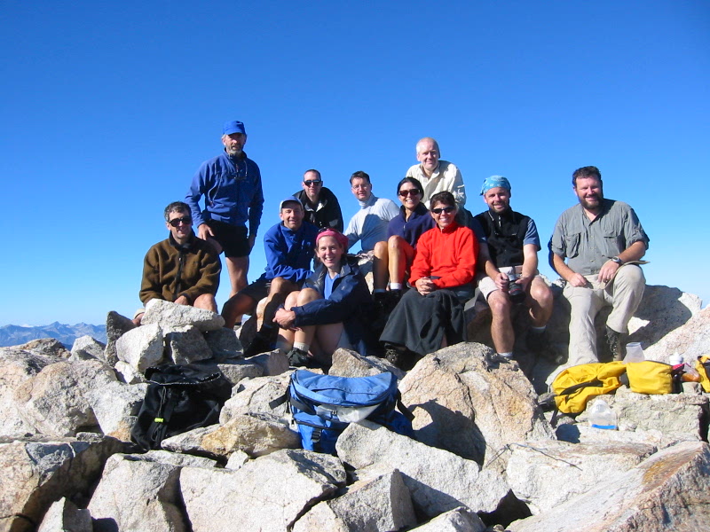 mountain climbers and hikers taking a break on the rocky boulder summit of Remmel Mountain in the Similkameen Mountains in the Pasayten Wilderness