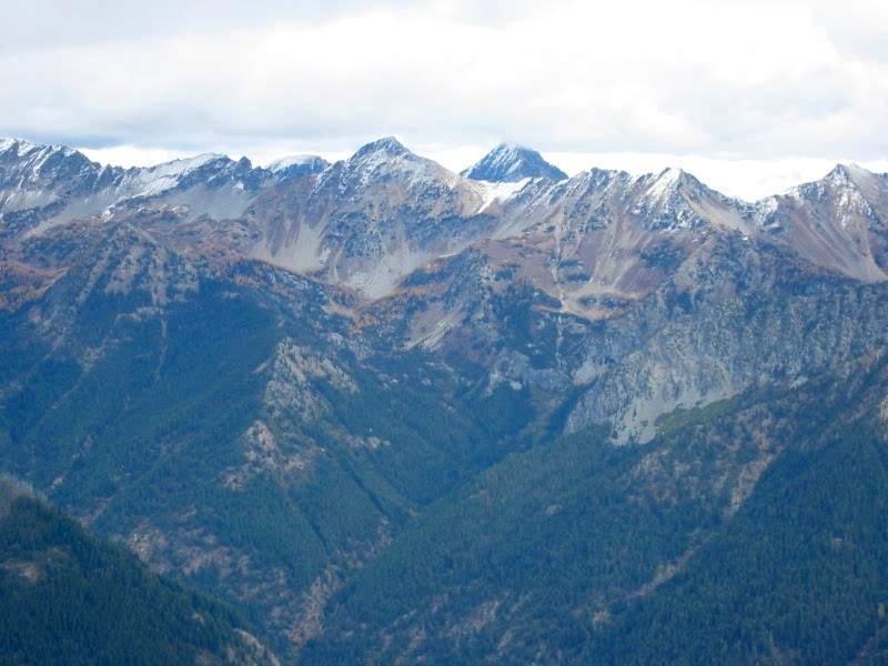 South Spectacle Butte in the Entiat Mountains being engulfed by clouds in the distance as seen from Little Giant Peak in the Chiwawa Mountains