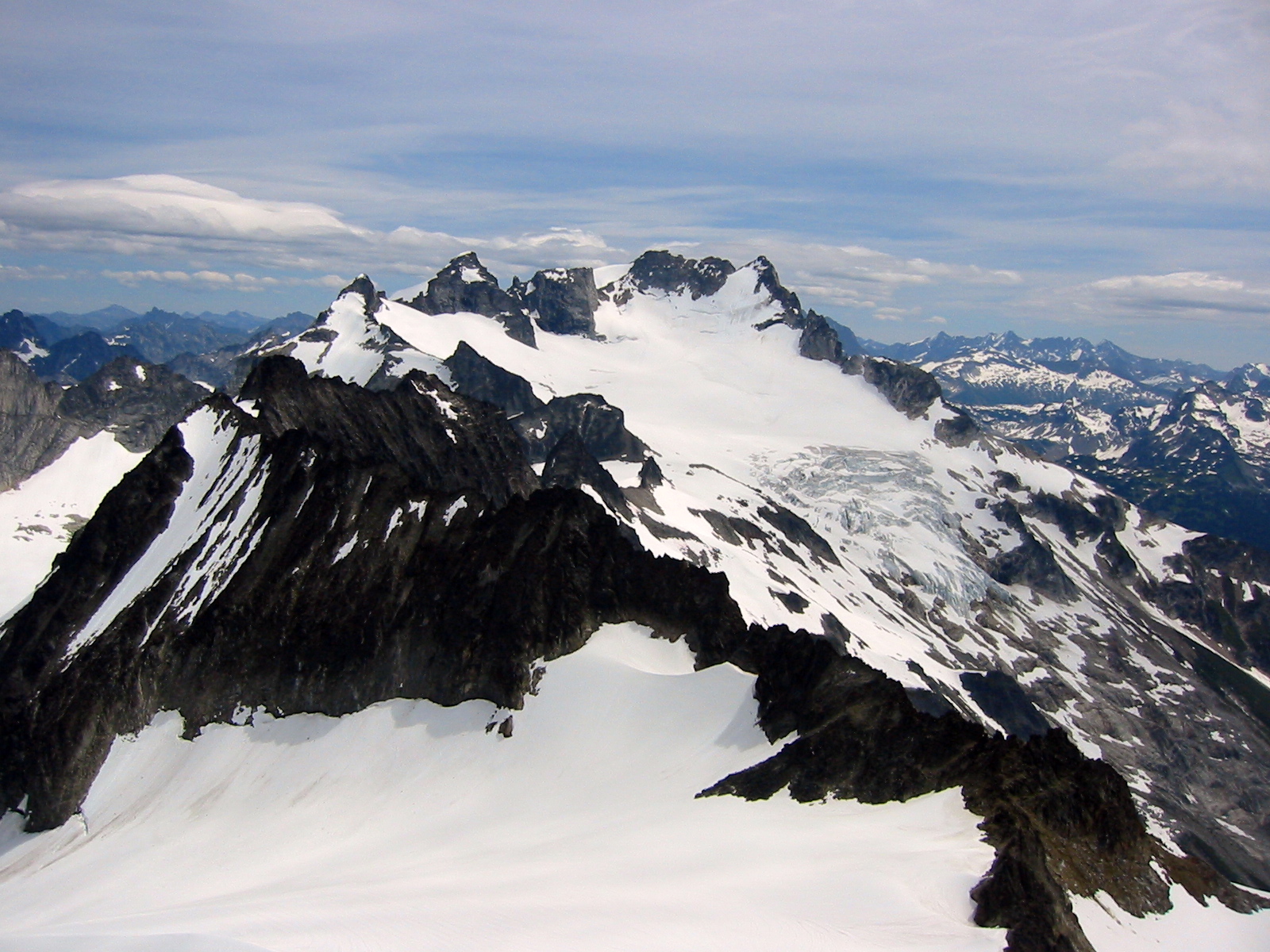 massive Dome Peak with snow patches as seen from the summit of Spire Point in the Glacier Peak Wilderness