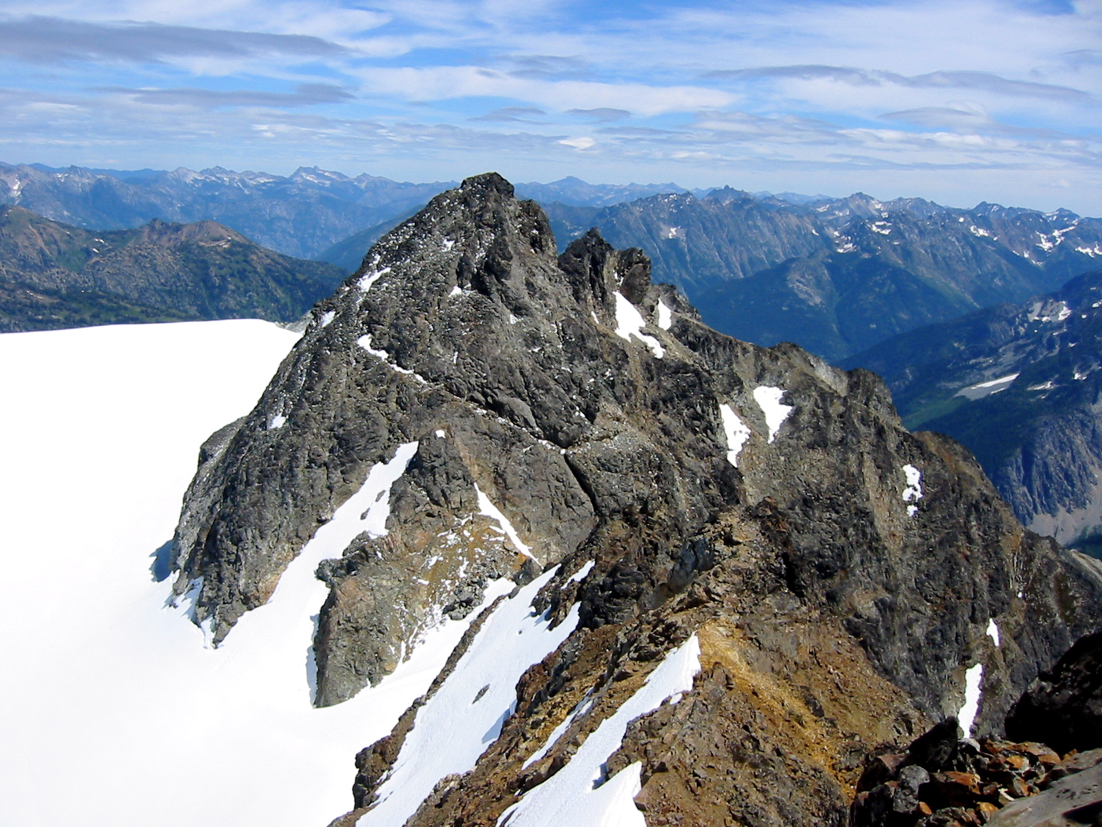 rocky Old Guard Peak with snow patches as seen from Sentinel Peak