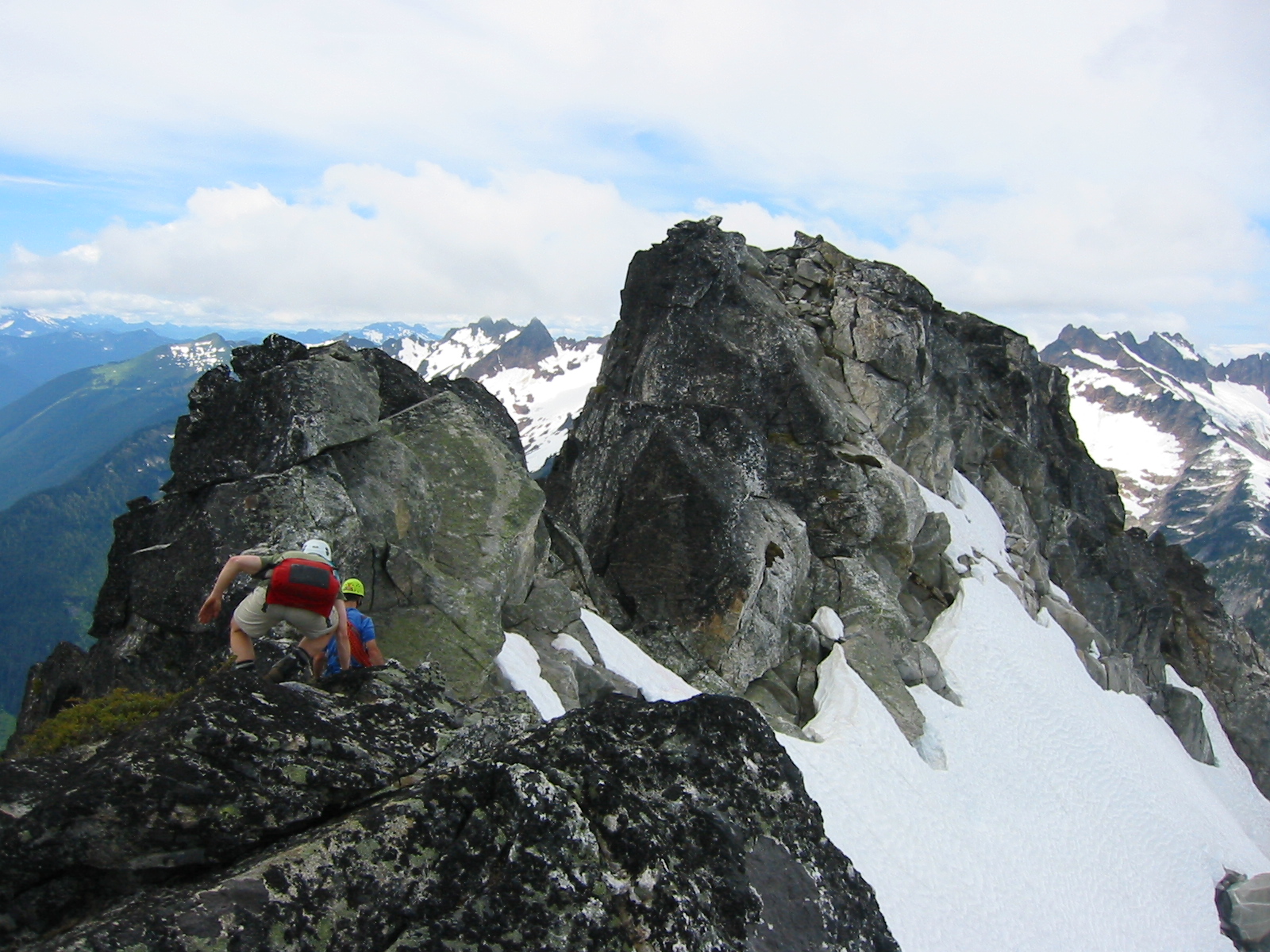 mountain climber scrambling the rocky East Ridge of Mt Bruseth