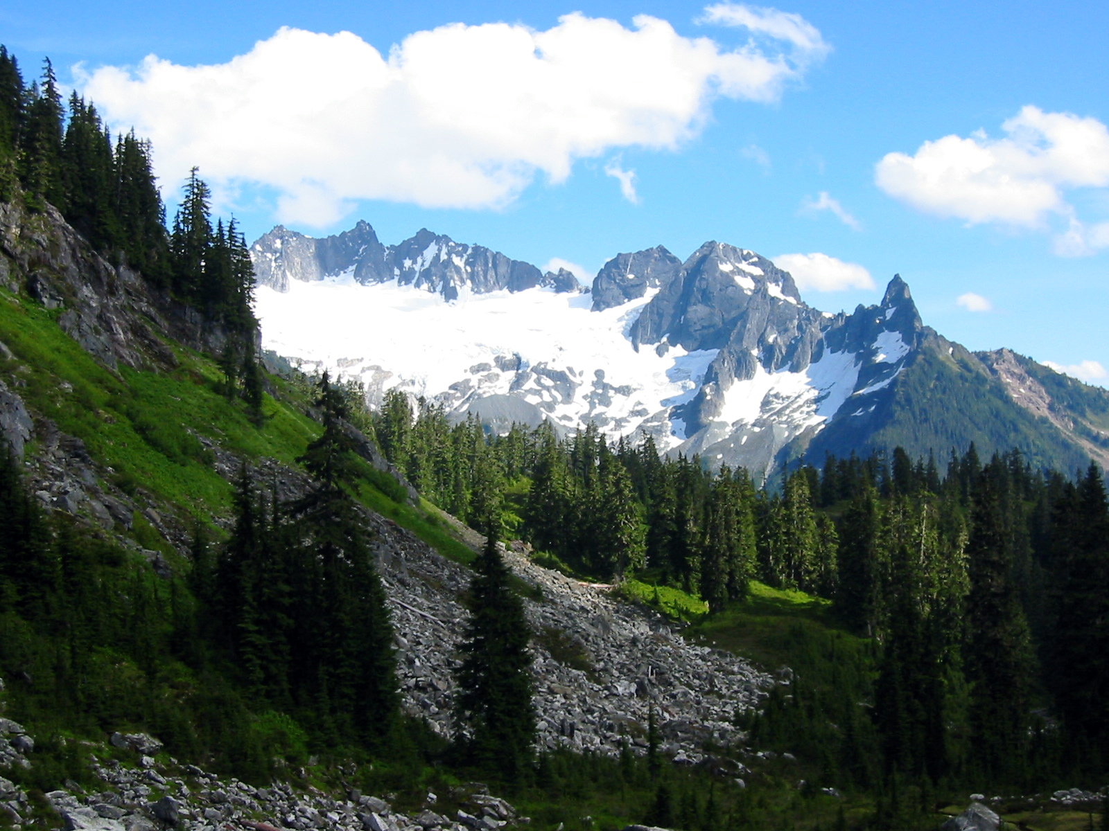 Spire Point with a rocky horn surrounded by snow as seen from Slim Pass