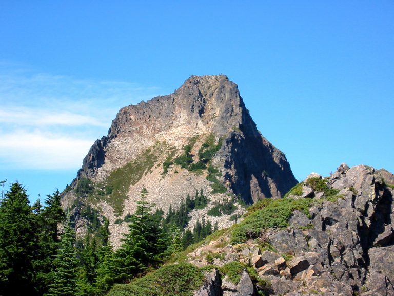 The steep face of Kaleetan Peak juts into a blue sky