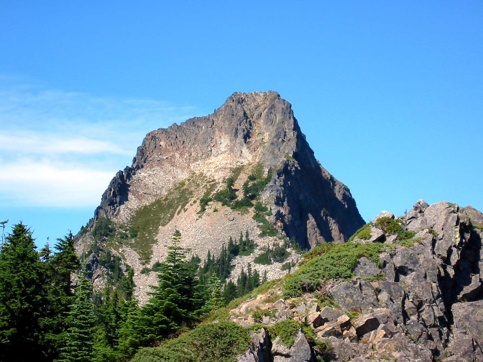 The steep face of Kaleetan Peak juts into a blue sky