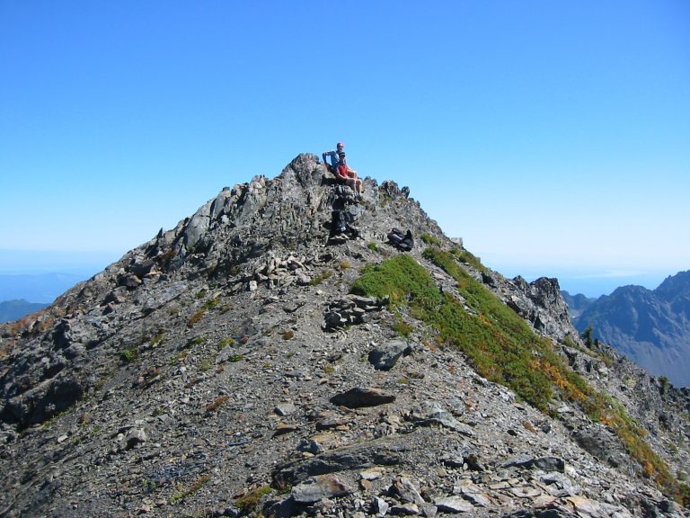 Two climbers sit atop the summit of Mt Skokomish on the edge of Olympic National Park