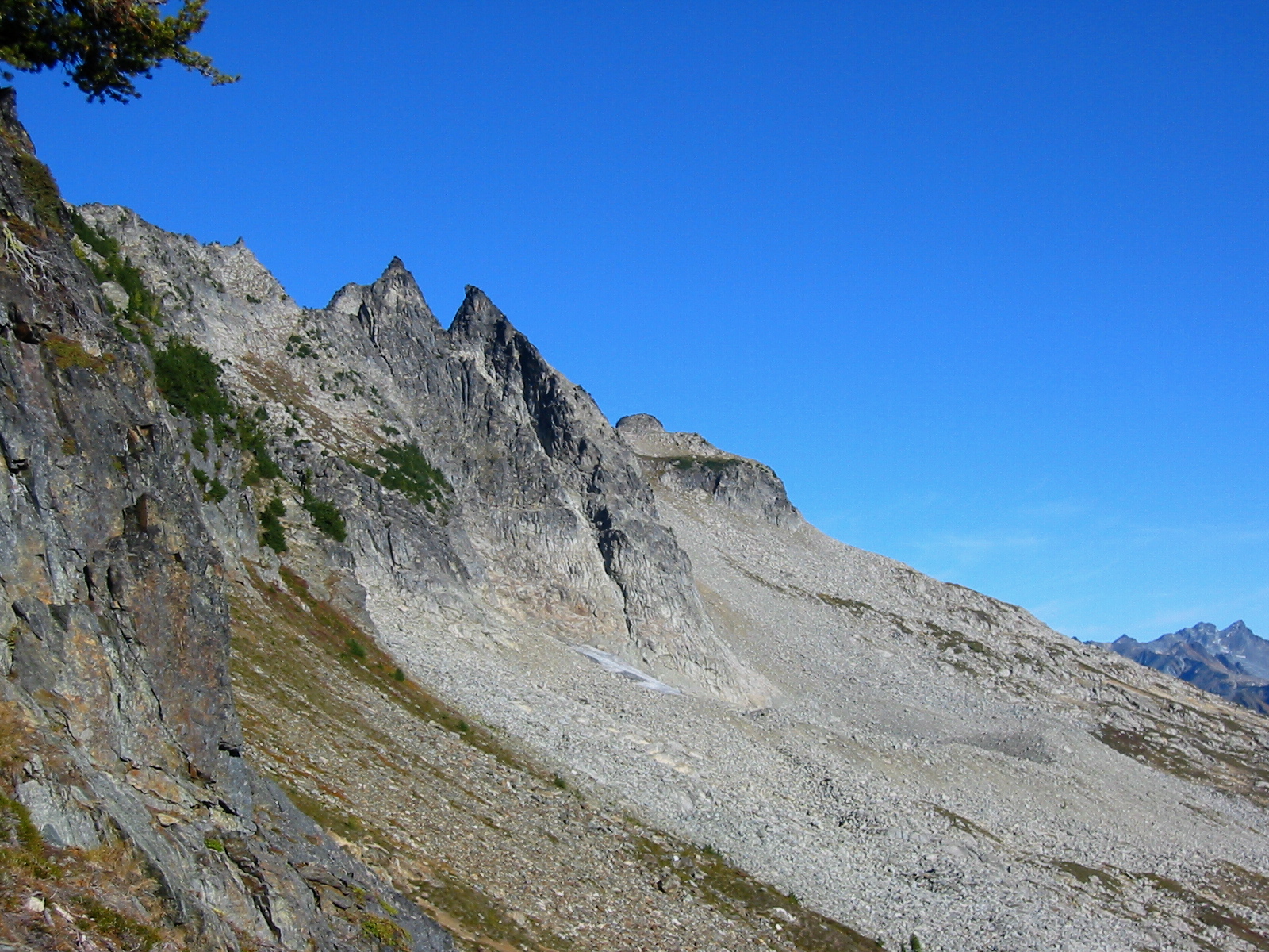 A gray talus slope leads up to craggy Bandit Peak