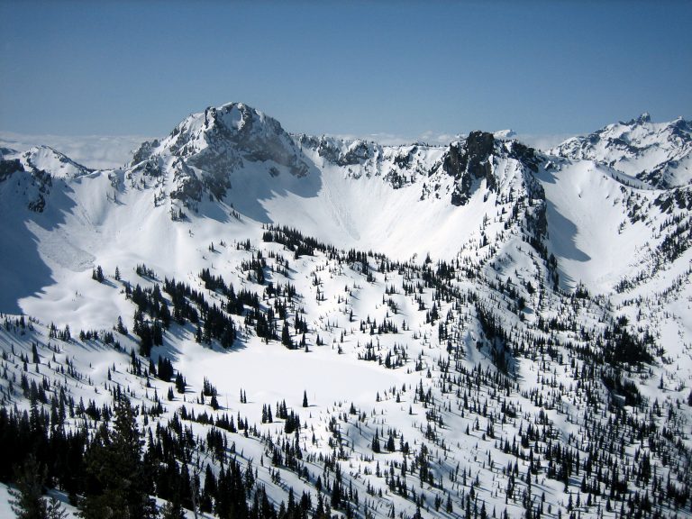 Chinook Peak stands above a snow-covered lake during the Chinook Peak Ski Circumnavigation