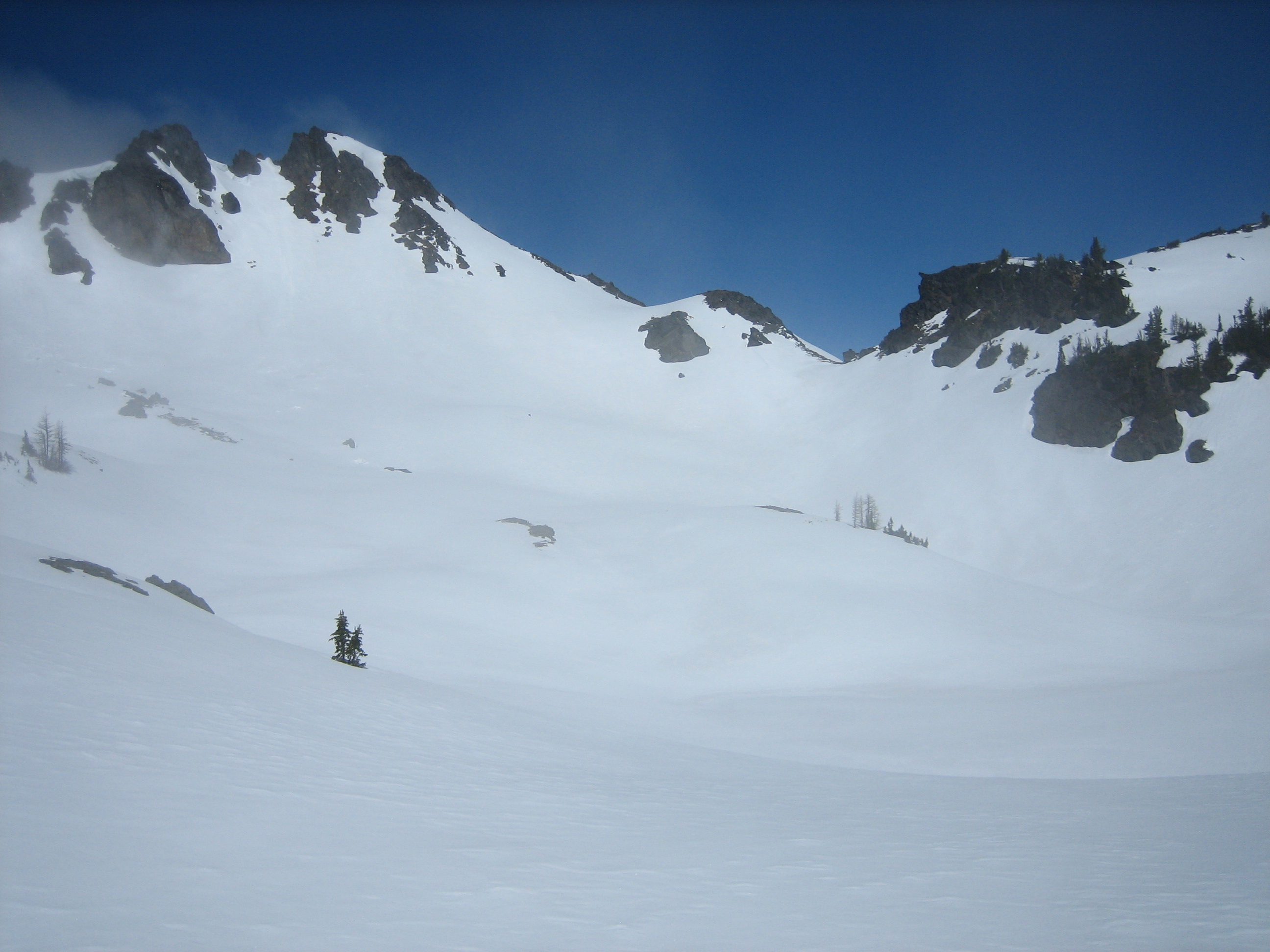 Snow slopes lead from a frozen lake up to Edna Pass and Cape Horn