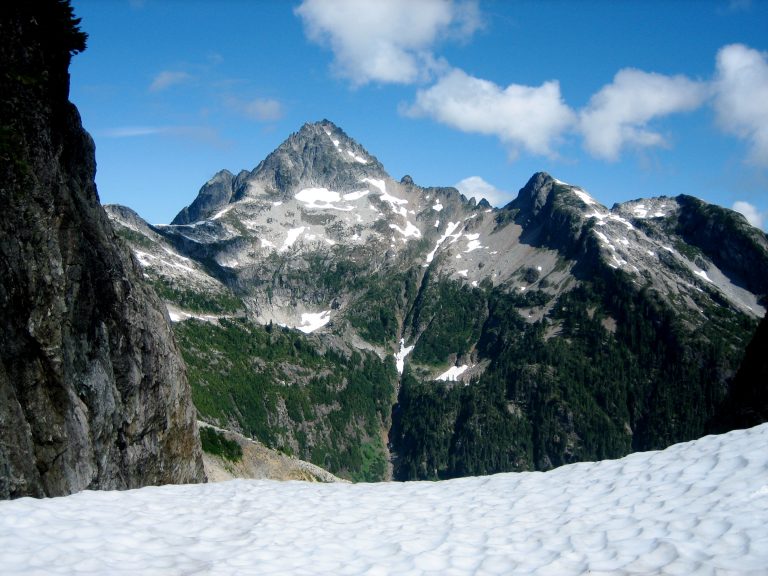 Mt Despair in the Lower Skagit Mountains stands behind a snow ridge at Triumph Pass in North Cascades National Park