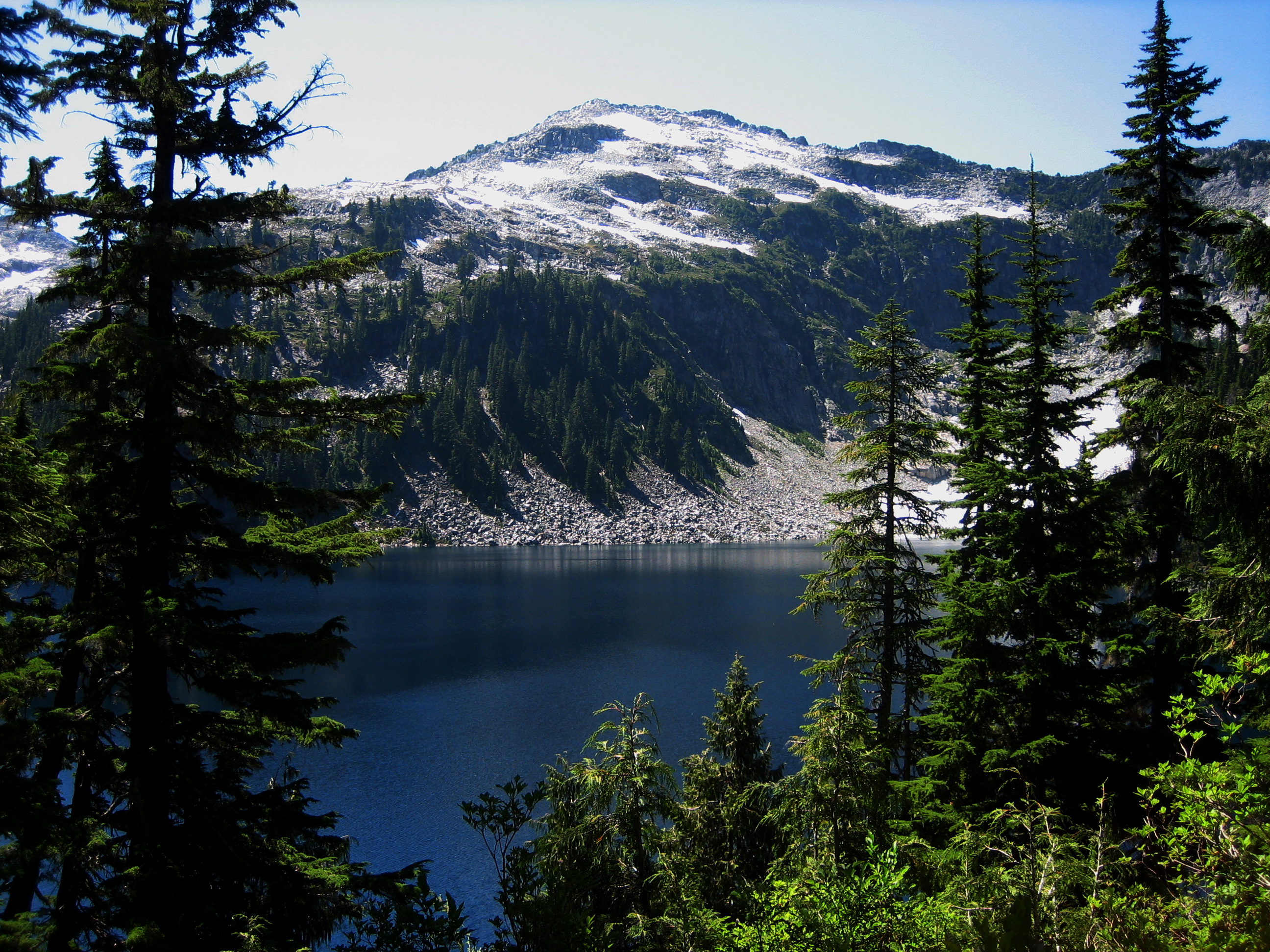 Camp Robber Peak stands above Big Heart Lake during the Big Heart Summit Loop