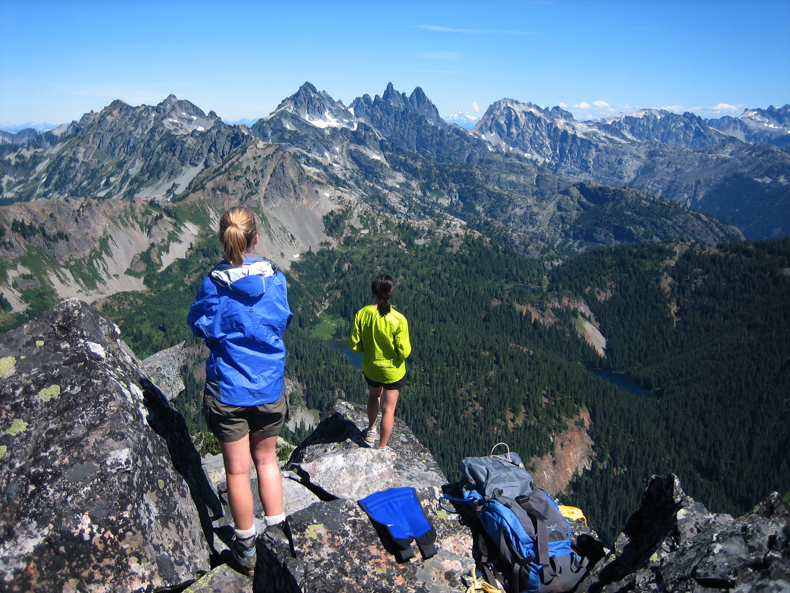 mountain climbers enjoying the view of the Snoqualmie Mountains from the rocky summit of Hibox Peak in the Alpine Lakes Wilderness