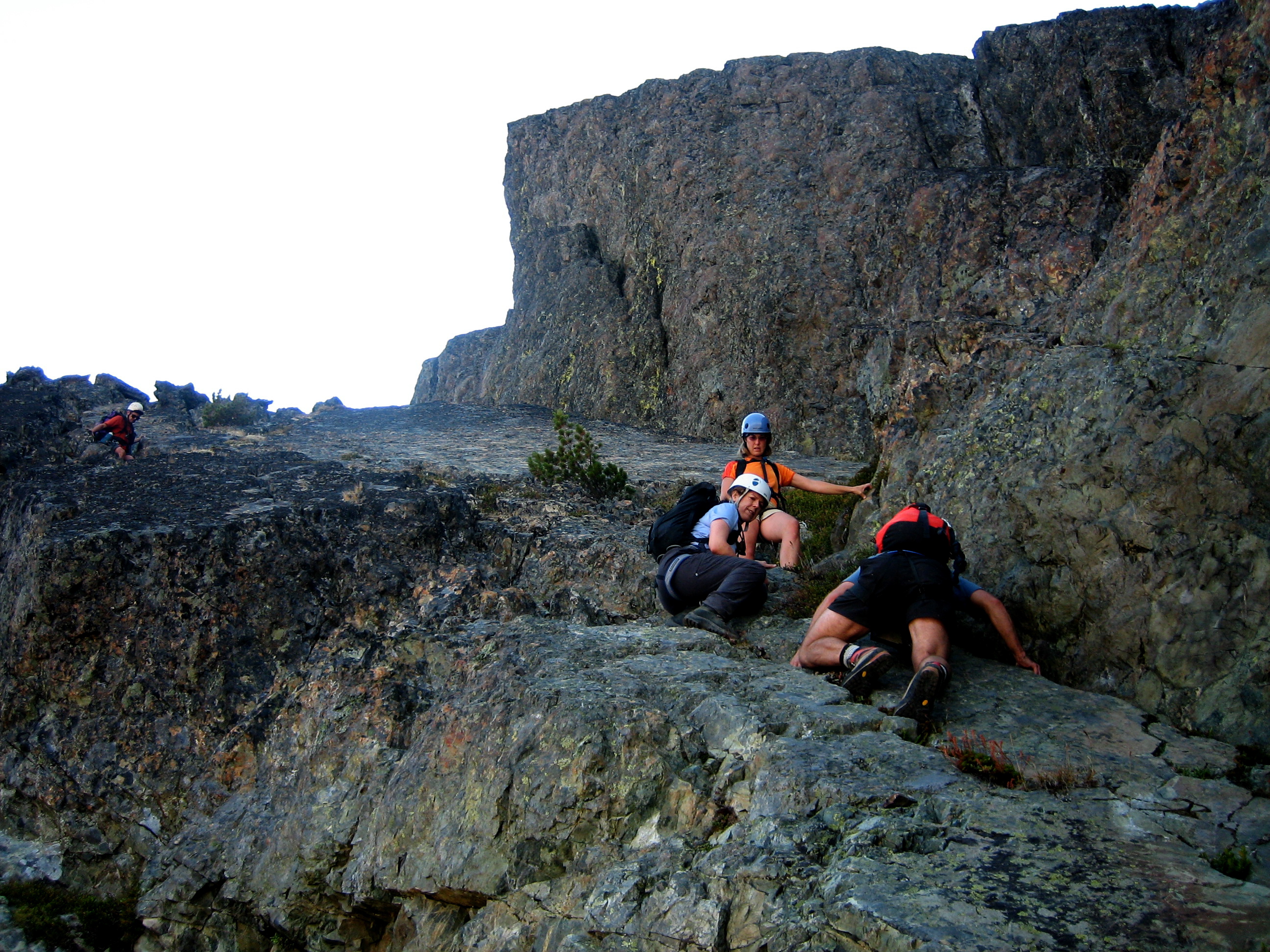 mountain climbers scrambling down steep rocky East Ledge of Mt Clark in the Olympic Mountain National Park
