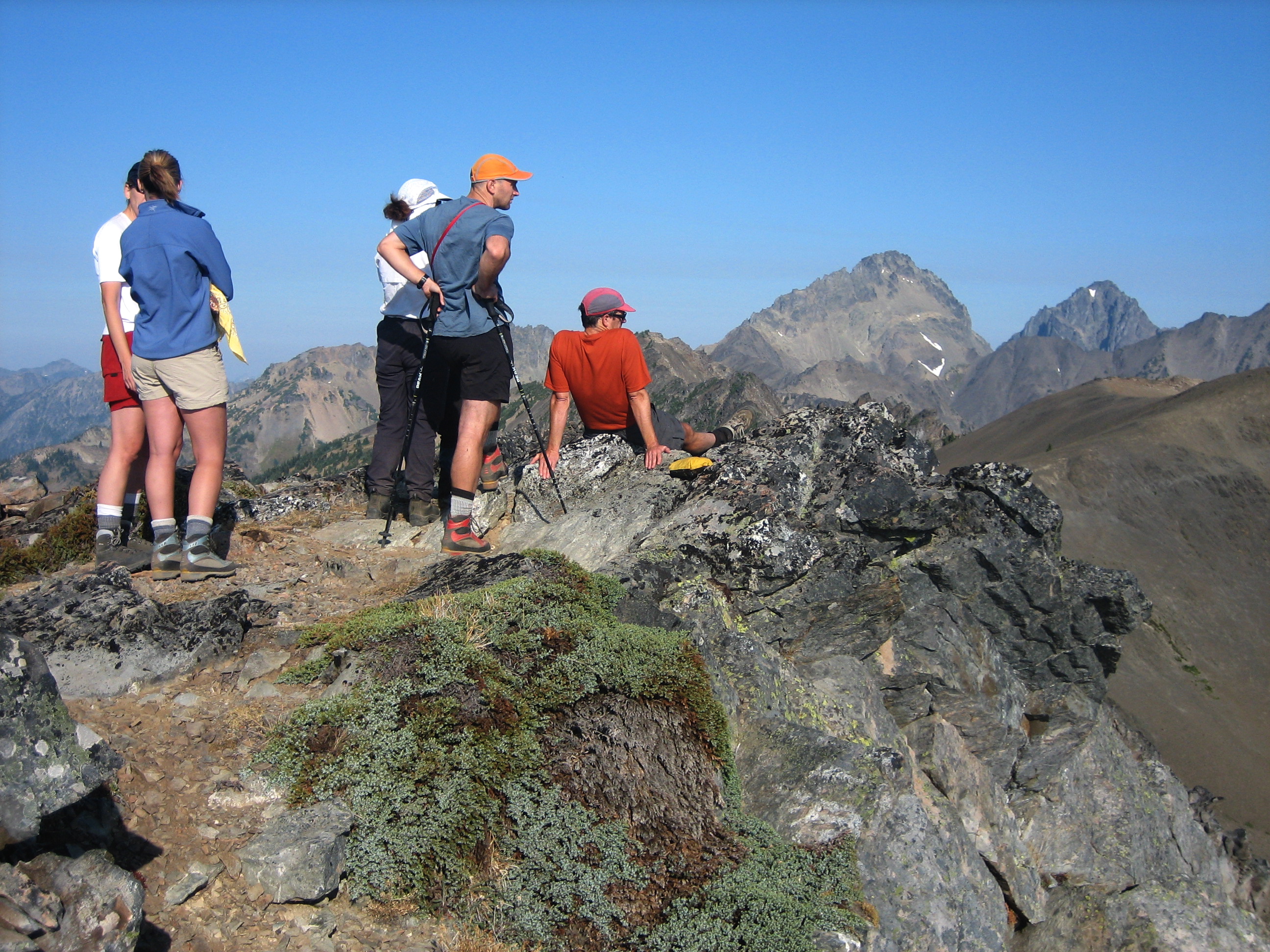 mountain climbers on a rocky ridge knoll in the Olympic Mountains