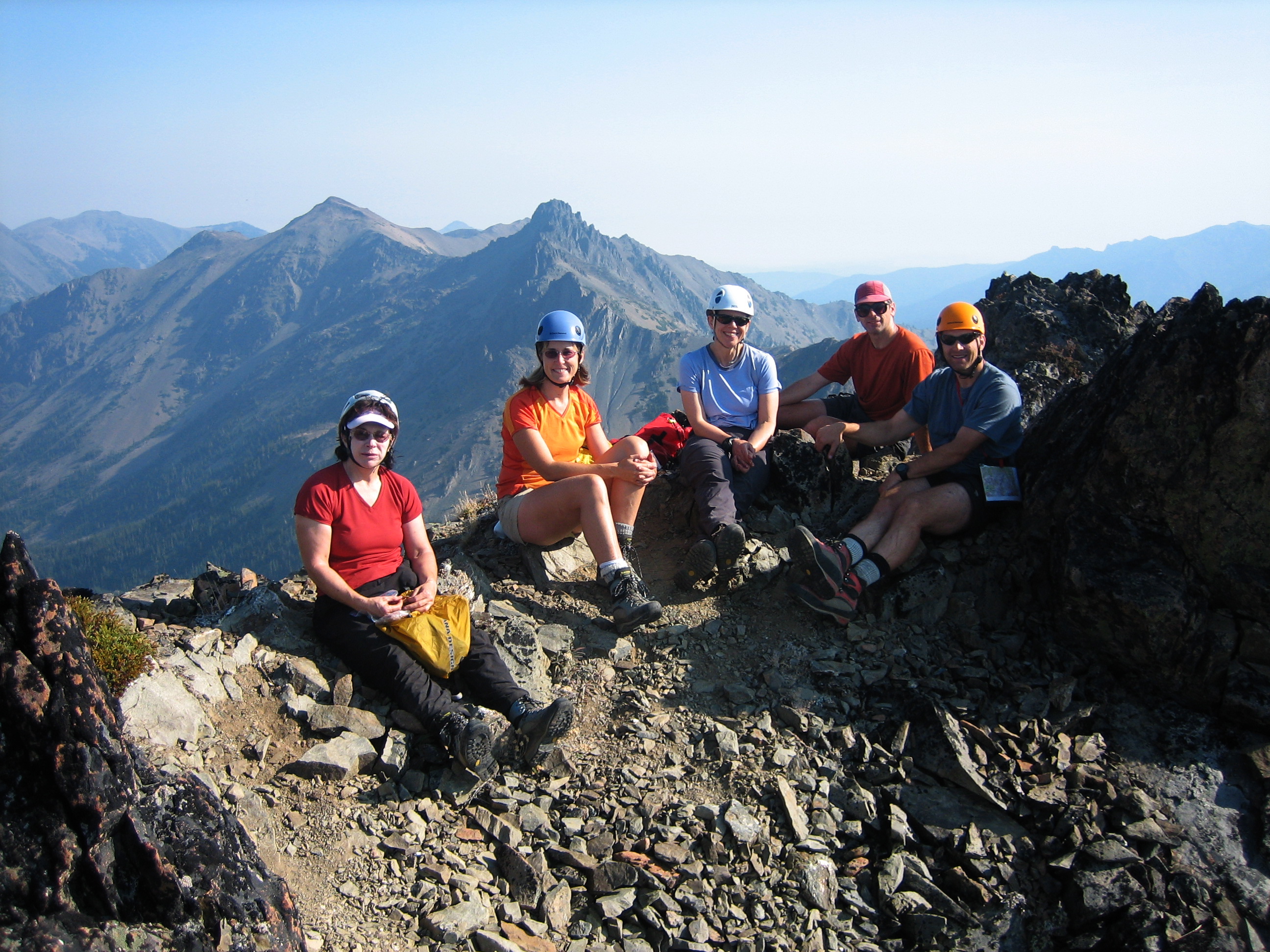 mountain climbers taking a break on the summit of Royal peak in the Olympic Mountains