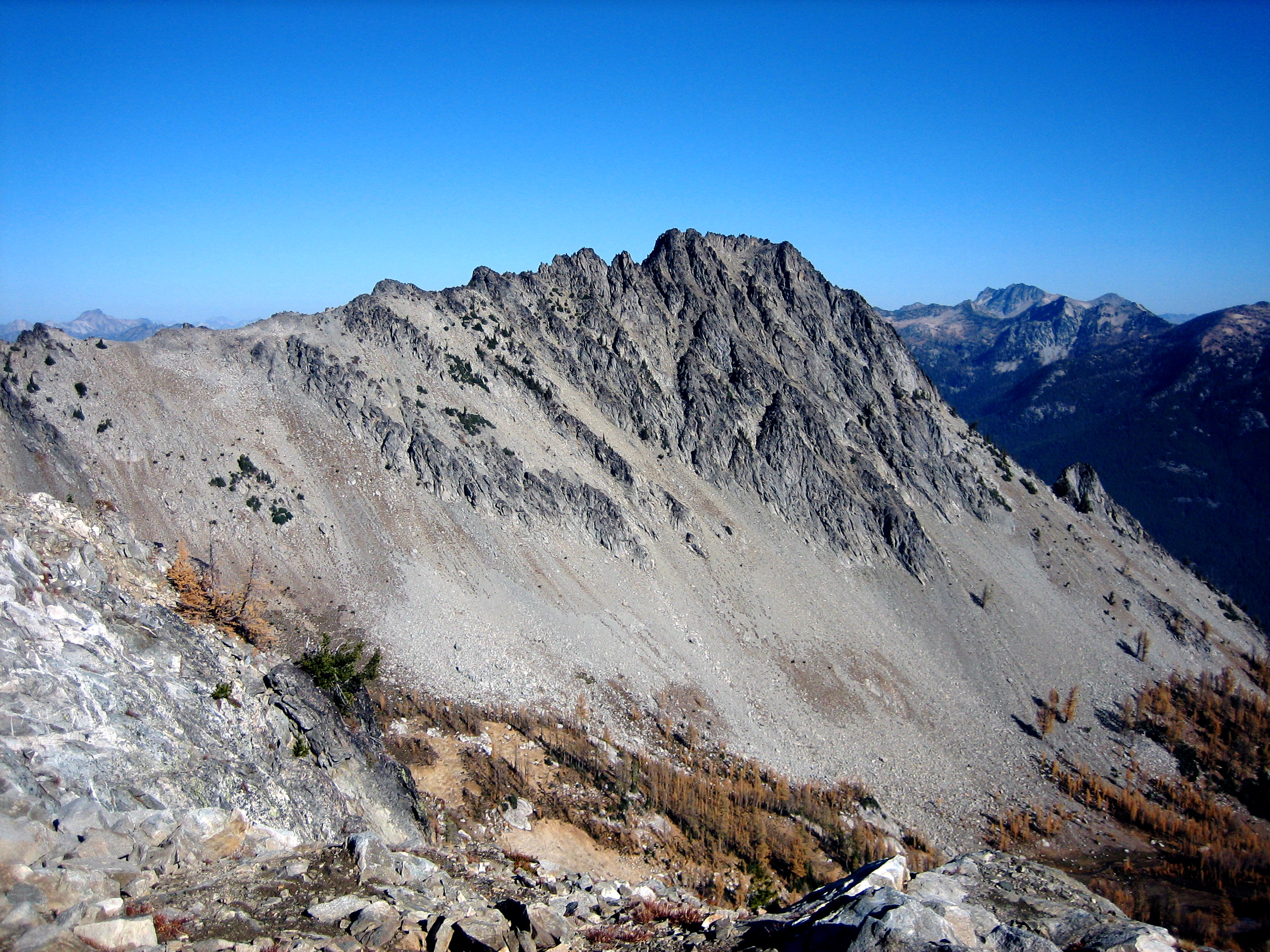 A long gray ridge leads out to craggy summit of Devils Smoke Stack
