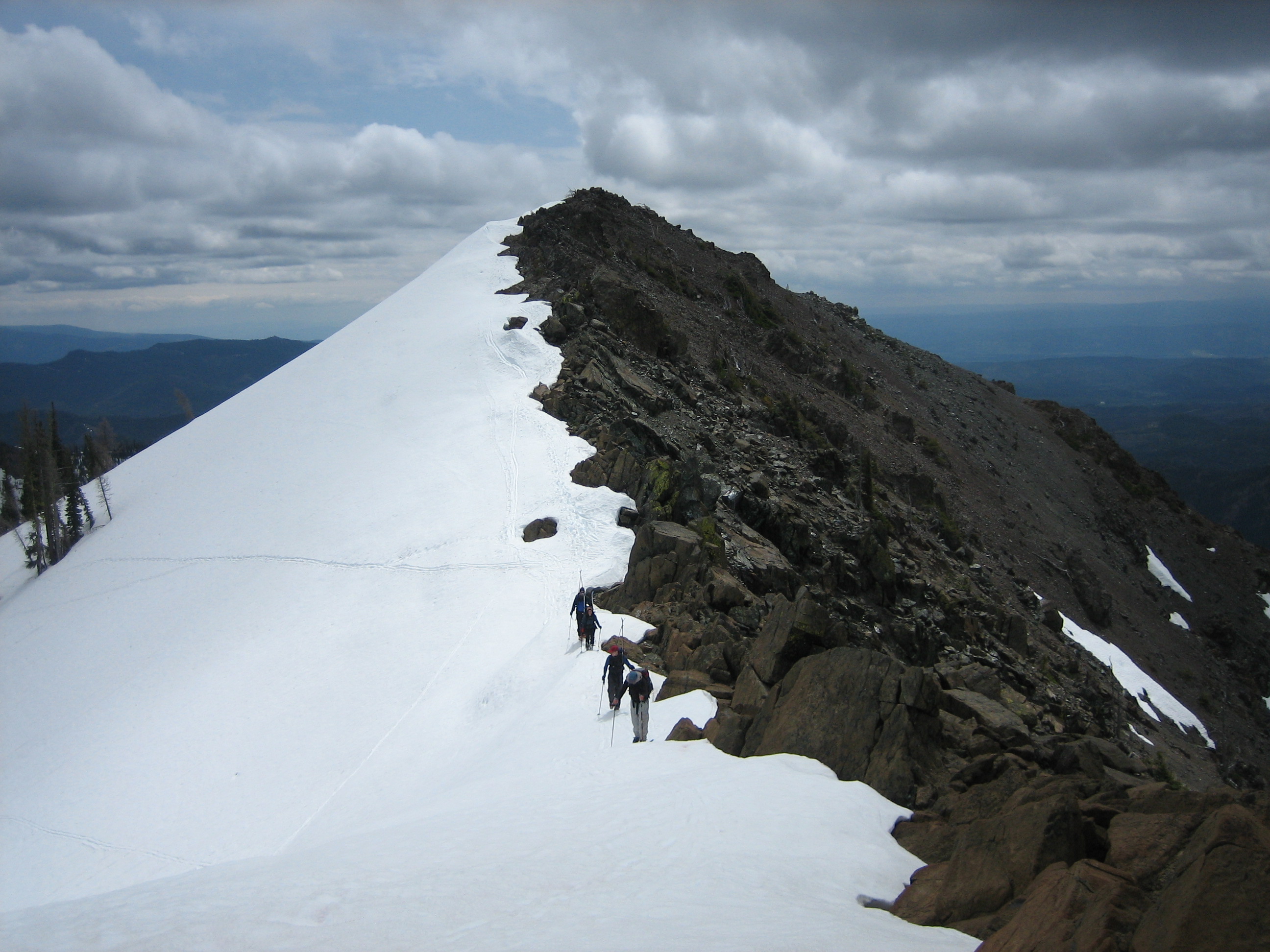 Backcountry skiers hike along the crest of a ridge leading to Beverly Peak
