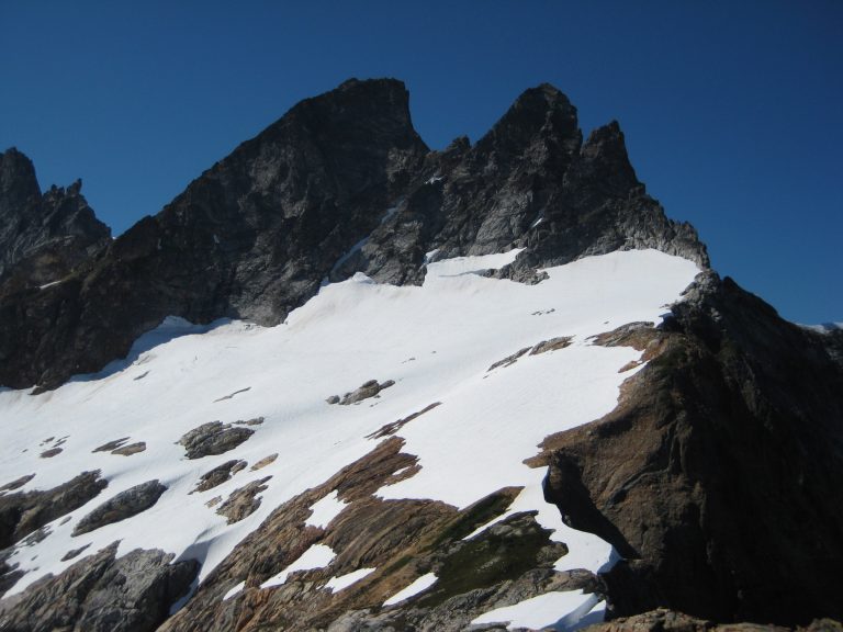 Two shark-tooth McMillan Spires rise above the Terror Glacier
