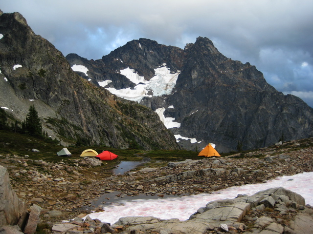 mountain climber's camp on the shores of Silent Lakes with Black Peak in North Cascades National Park in the background
