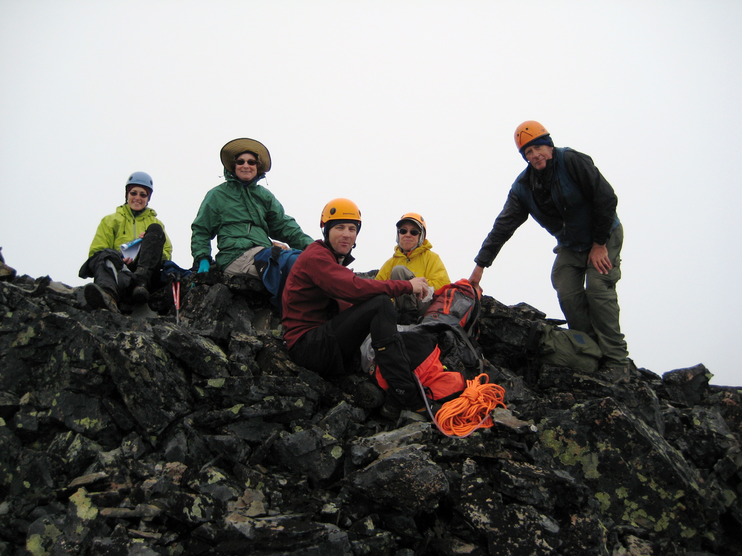mountain climbers sitting on the rocky summit of Mt Arriva in North Cascades National Park