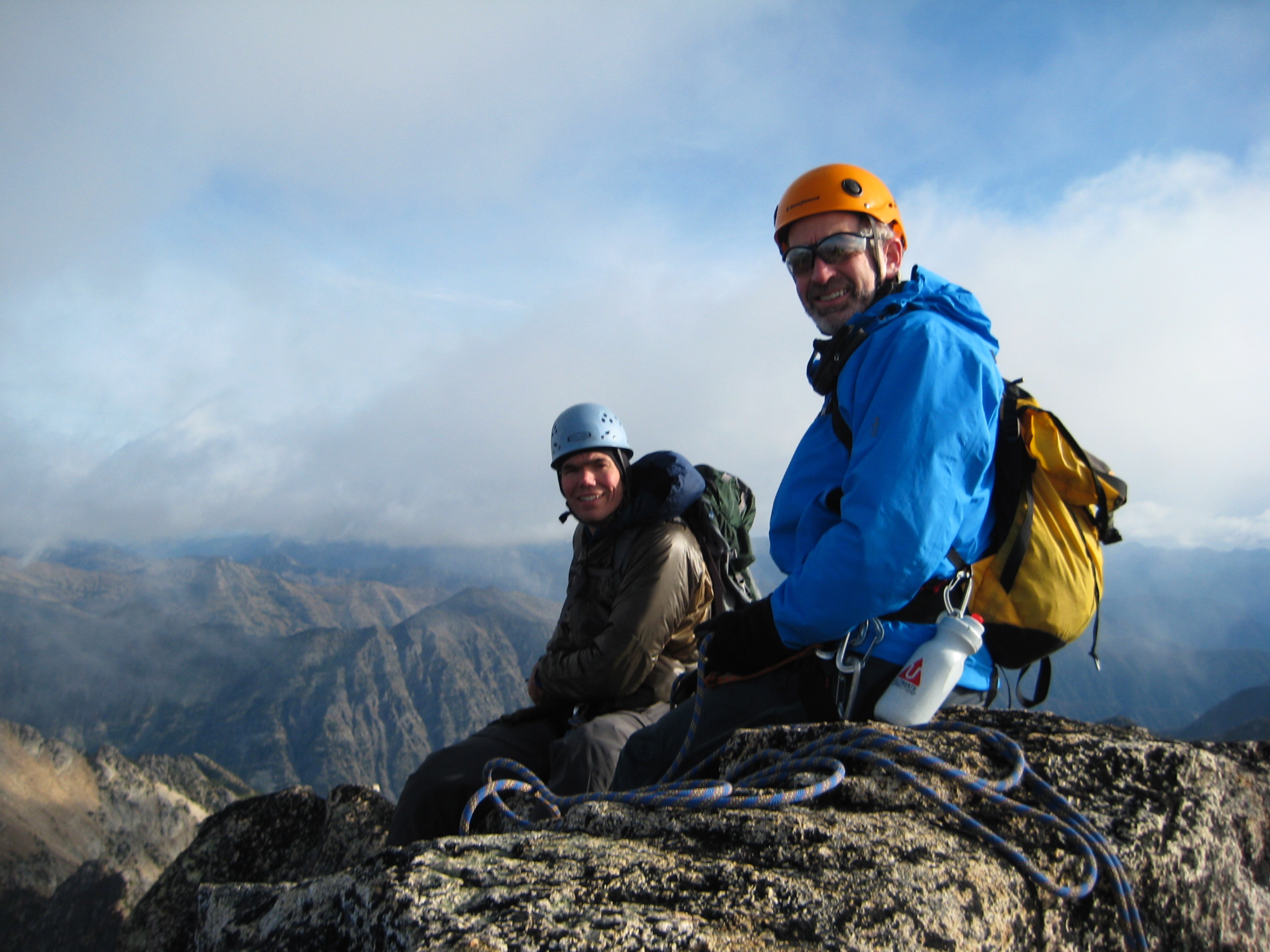roped mountain climbers taking a break on the rock, slab summit of Golden Horn peak in the Upper Methow Mountains
