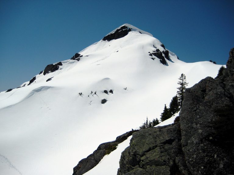 Snow-covered Tailgunner Peak juts into the sky