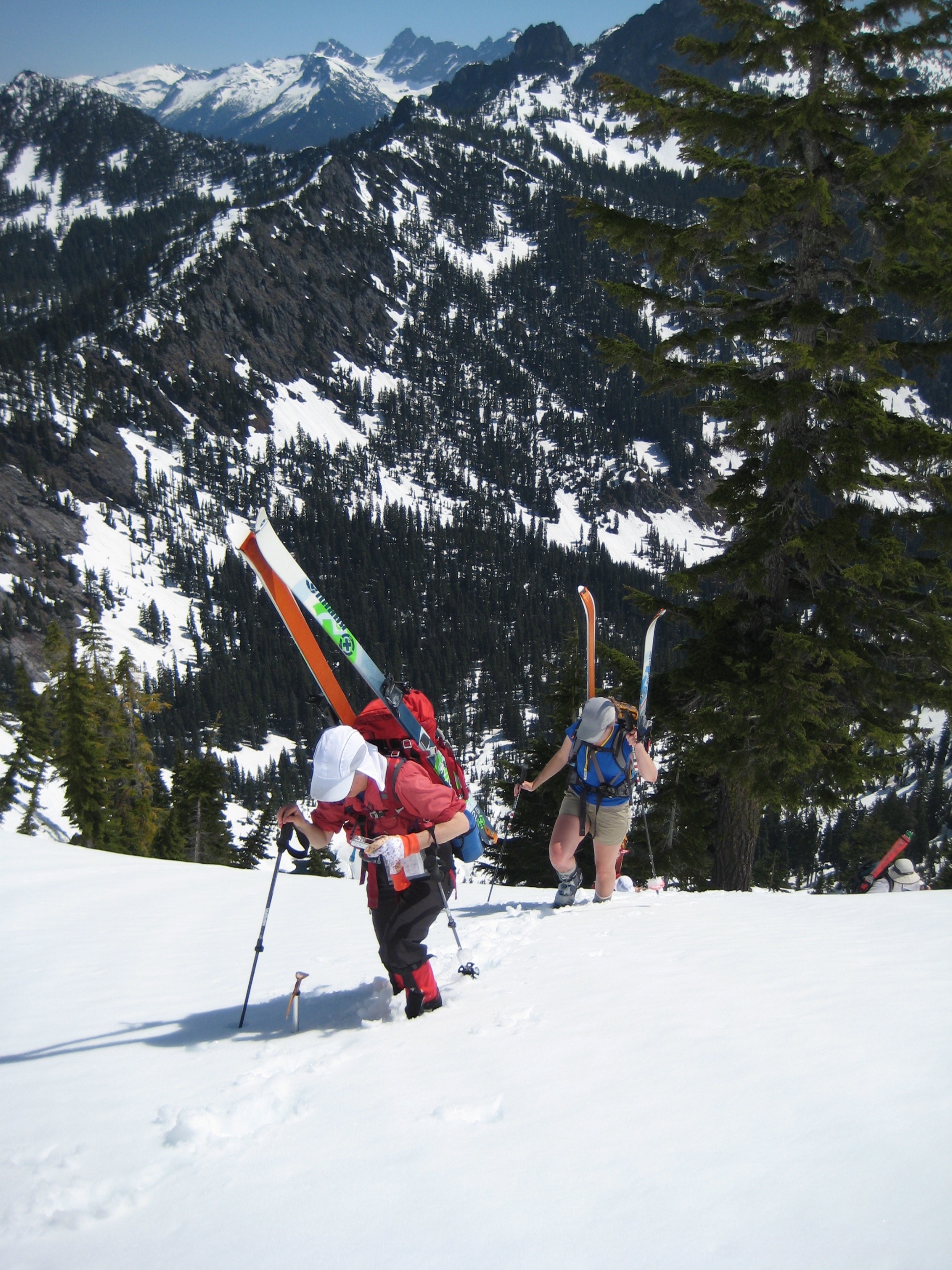 backcountry skier booting up snow slope above Pineapple Basin on the Chair Peak Circumnavigation Ski Tour