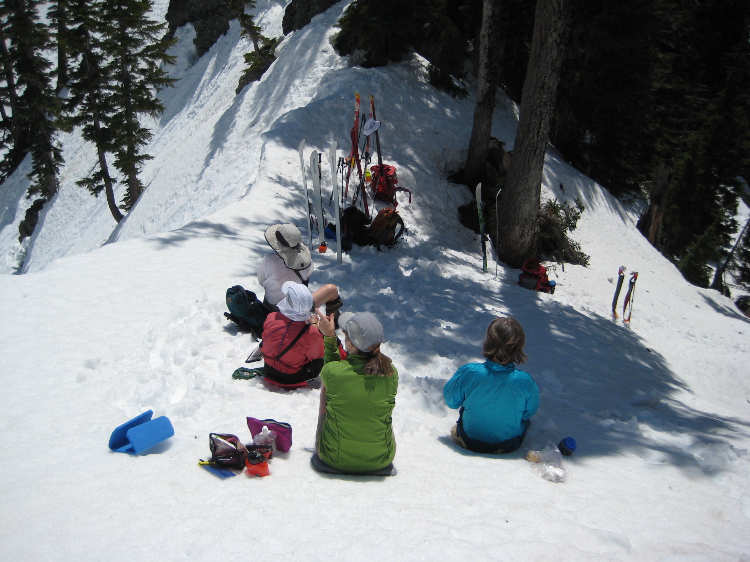 backcountry skiers taking a break on Bryant Col in the Snoqualmie Mountains
