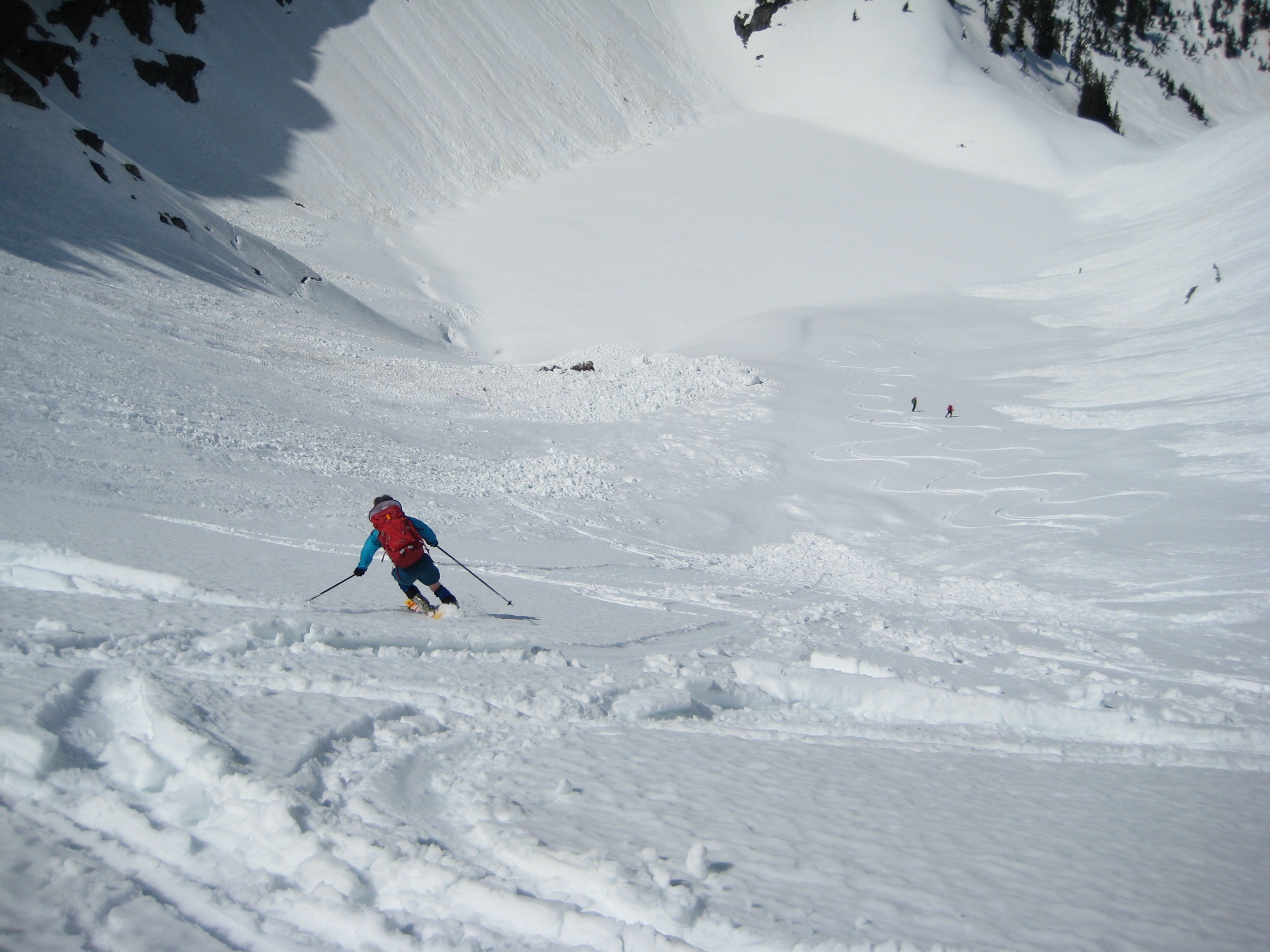 a lone backcountry skier making tracks in the snow during the descent from Melakwa Pass