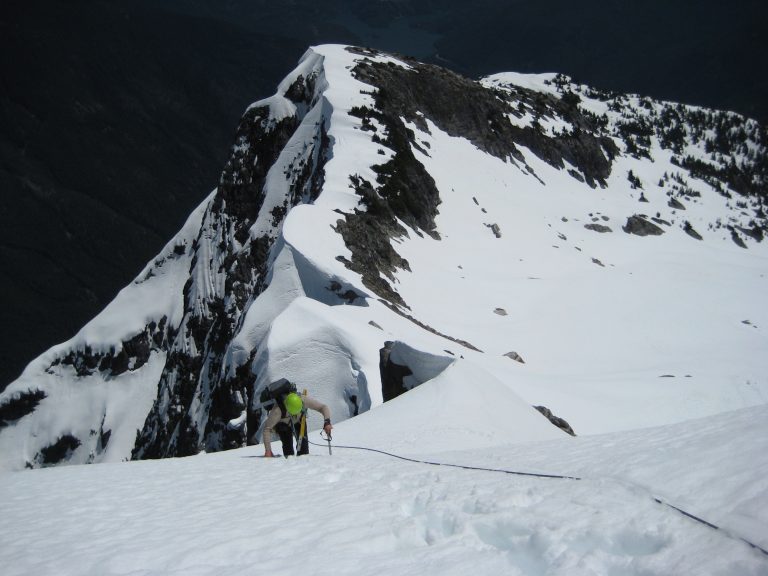 A mountain climber ascends a steep snow slope on Davis Peak near Diablo
