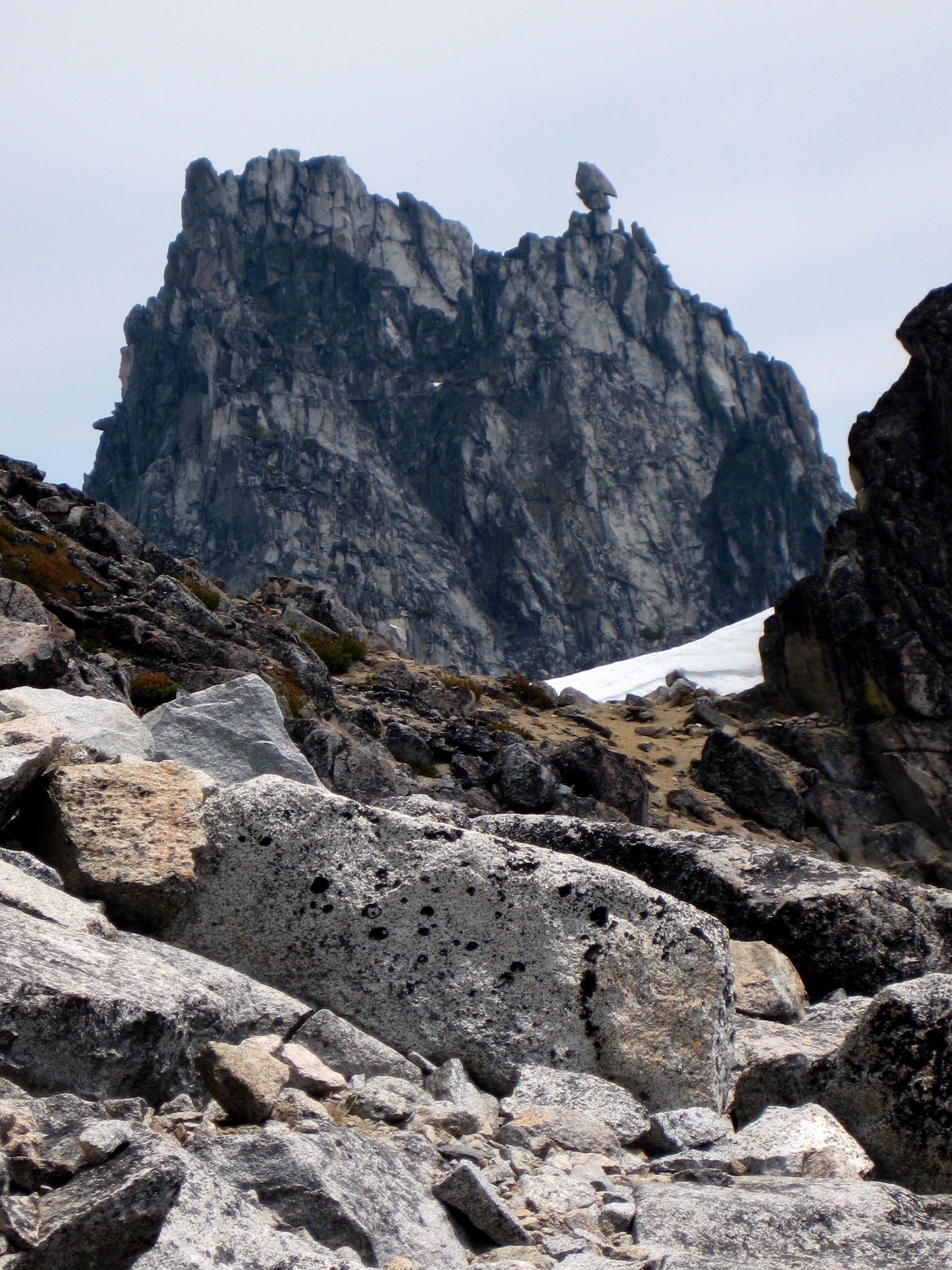 Sherpa Peak with arrowhead tower with a boulder field in the foreground