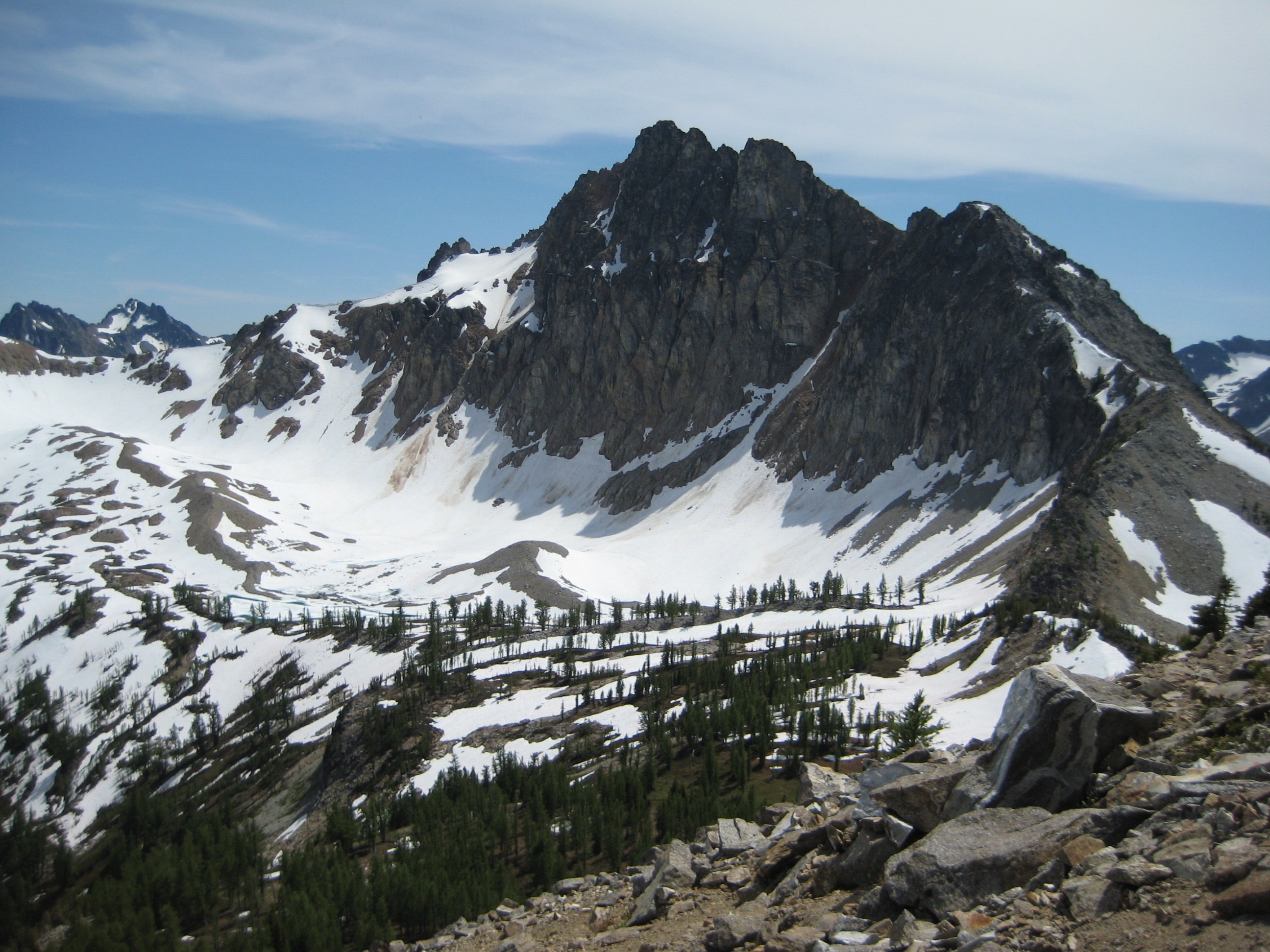 The craggy face of Devore Peak stands over snow-bound Bird Lake Basin in the Glacier Peak Wilderness