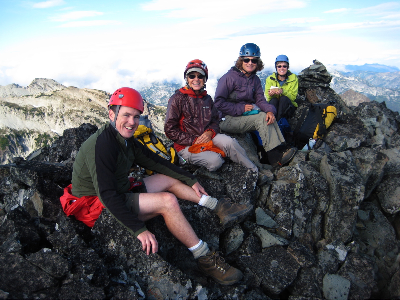 mountain climbers taking a break on the rocky summit of The Citadel in the Alpine Lakes WIlderness