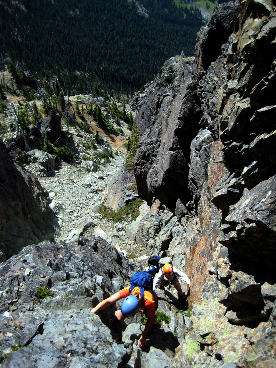 looking down on mountain climbers scrambling up the gully on Cathedral Rock in the Alpine Lakes Wilderness with a scree basin below