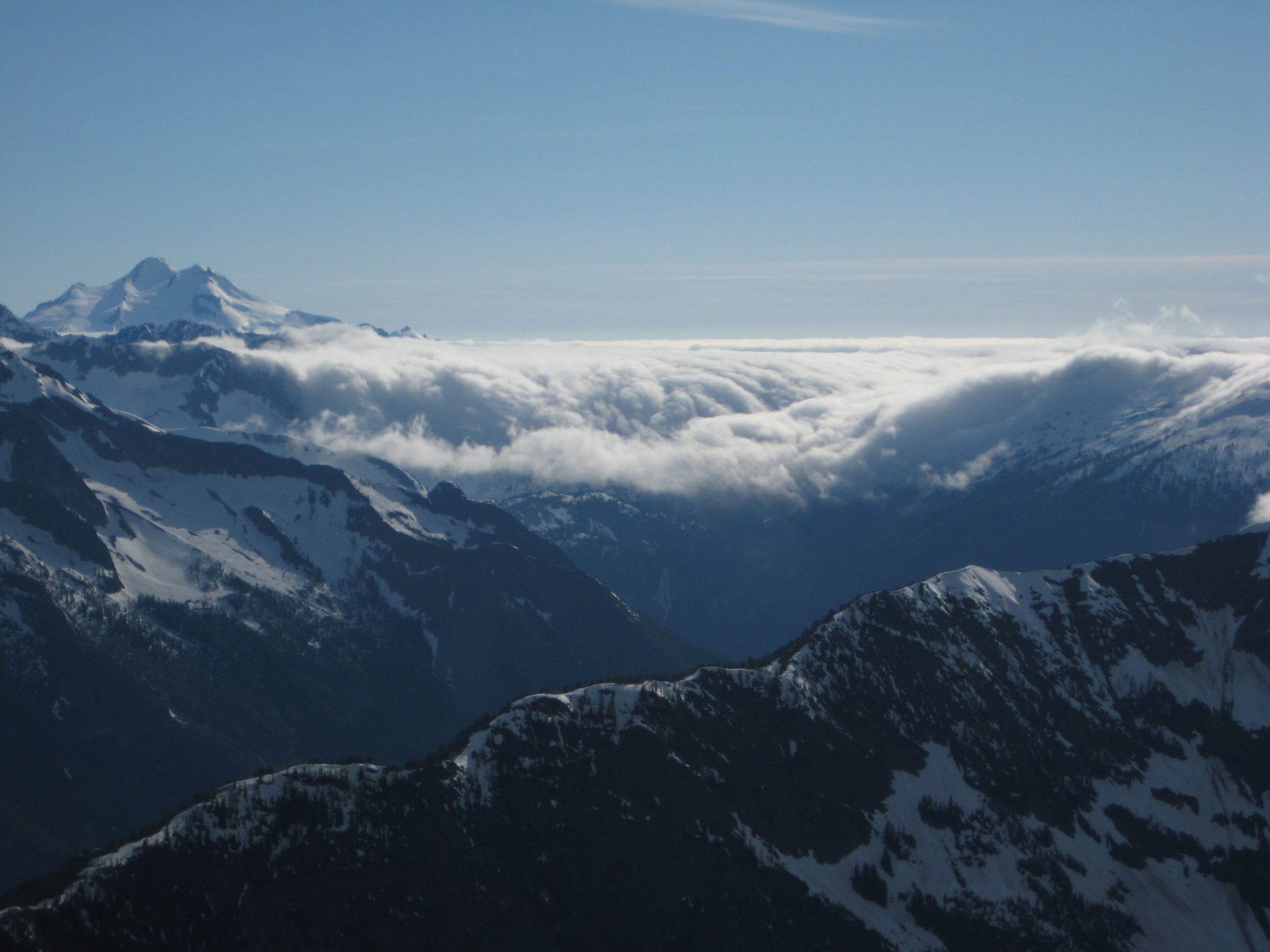 cloud bank rolling over the Cascade fMountains as seen from the summit of Riddle Peak in the Glacier Peak WIlderness