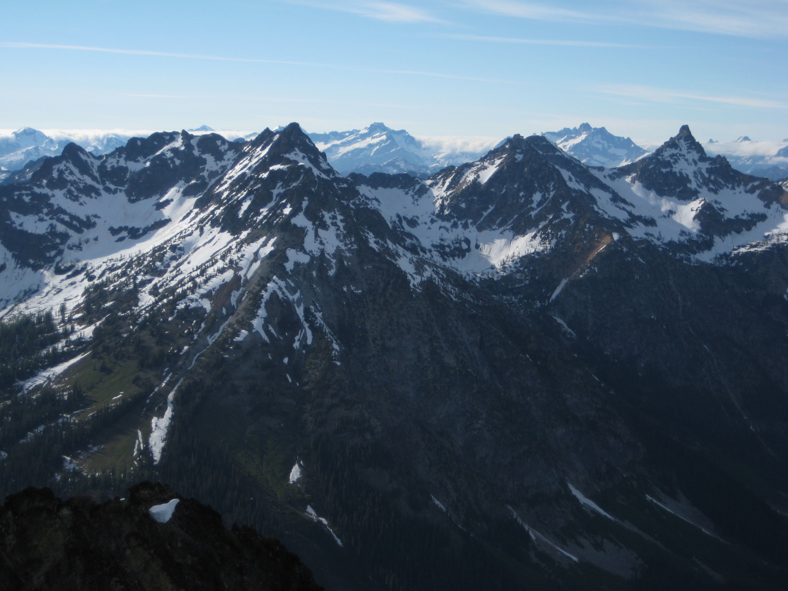 WyEast Mountain, WyNorth Mountain, and Devore Peak with the mountains of Glacier Peak WIlderness in the background as seen from the summit of Main Riddle Peak in the Stehekin Mountains