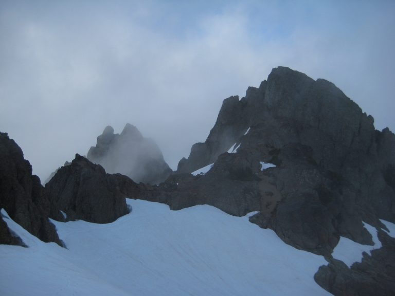 Clouds swirl around the rocky peaks of Mt Stone