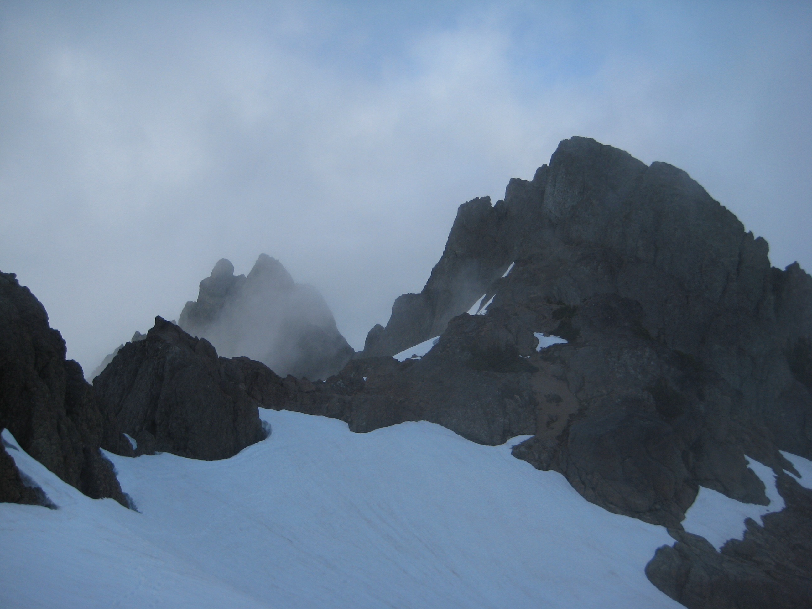 Clouds swirl around the rocky peaks of Mt Stone