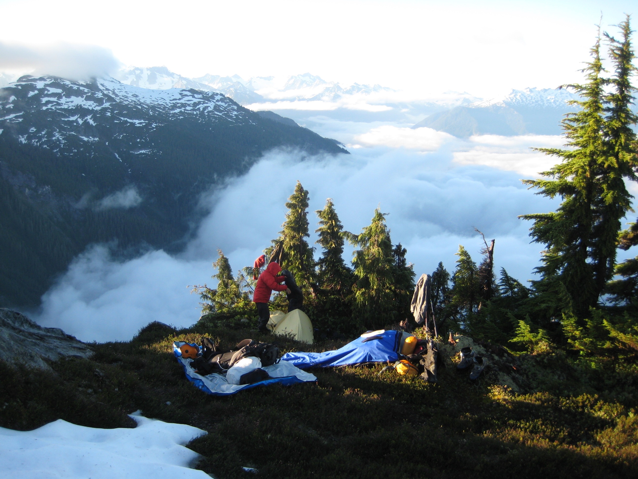 climbers camp in the morning with the fog lifting as the climbers dry out their gear