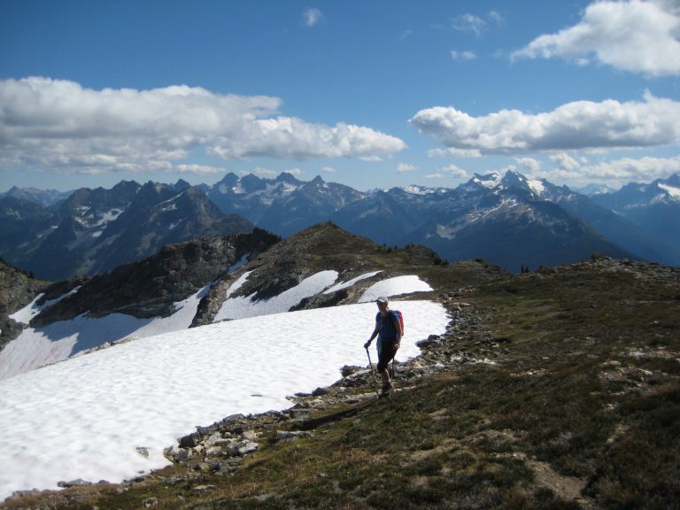 A solo hiker walks along a ridge high on Ruby Mountain in the North Cascades