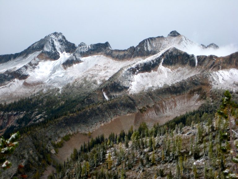 Autumn snow puts a white dust over Monument Peak and Blackcap Mountain in the Pasayten Wilderness