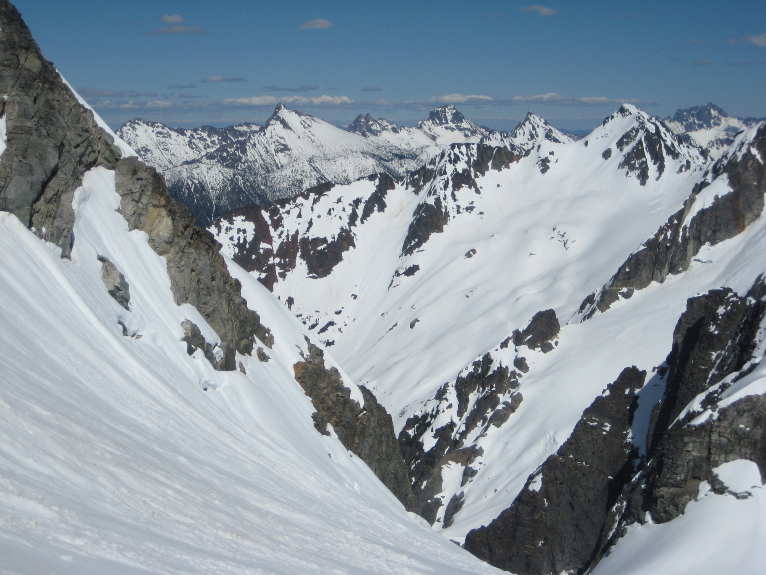 snow covered Methow Mountains and Kitling Peak on the Ragged Ridge with the steep Kimtah Glacier in the foreground