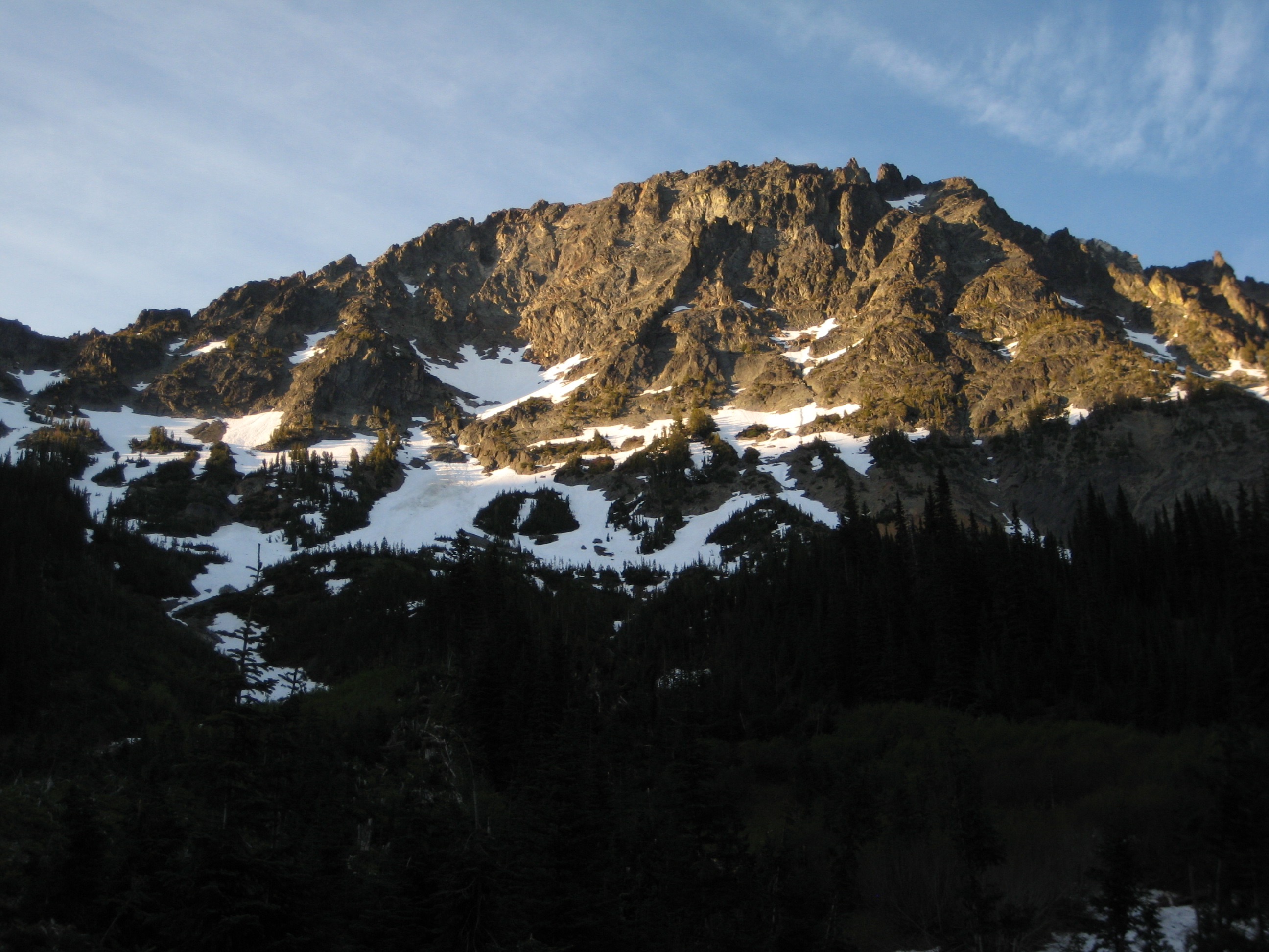 Golden sunlight highlights the broad face of Martin Peak