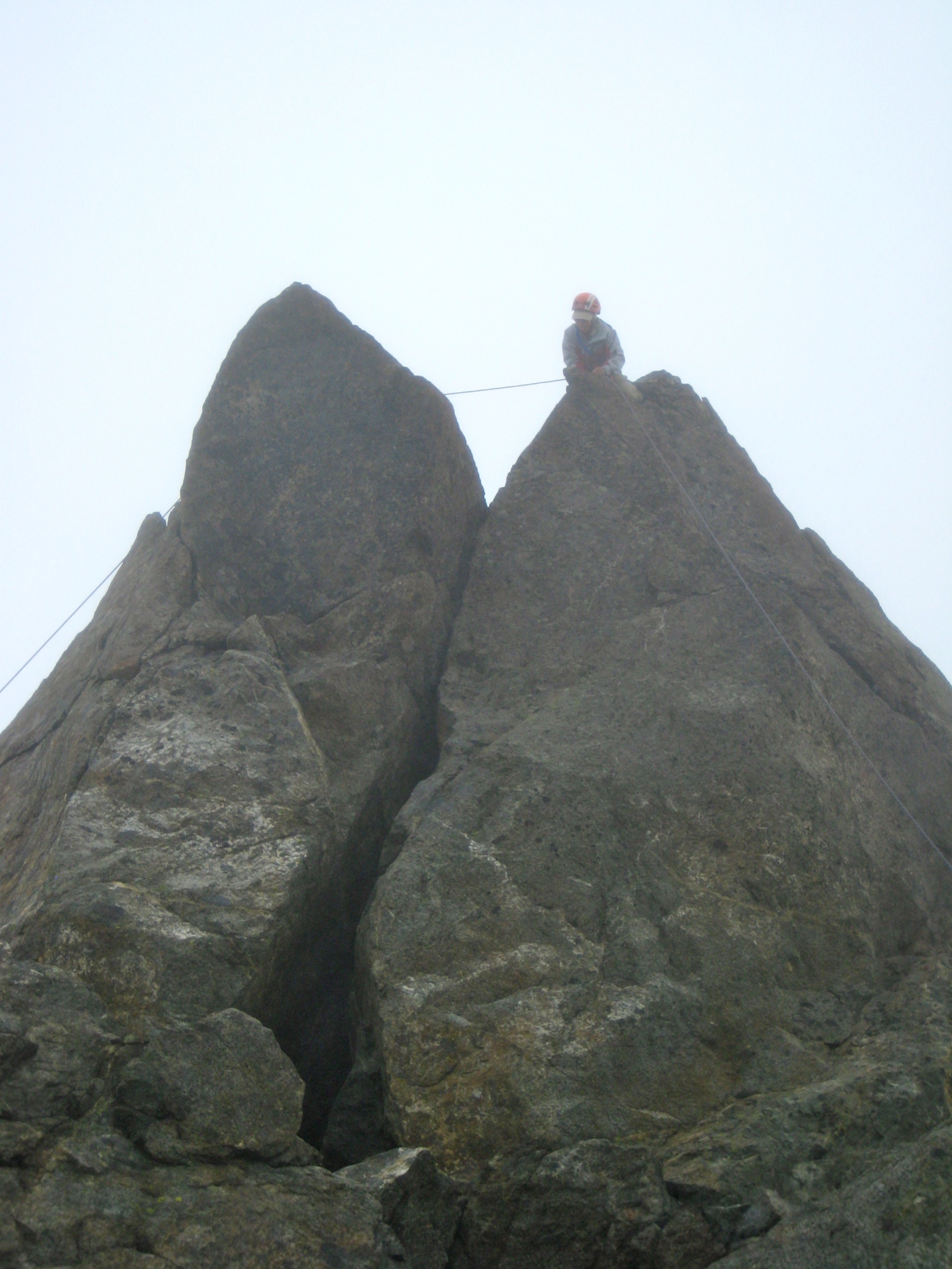 climber on the foggy summit of North Brother in the Olympic Mountains