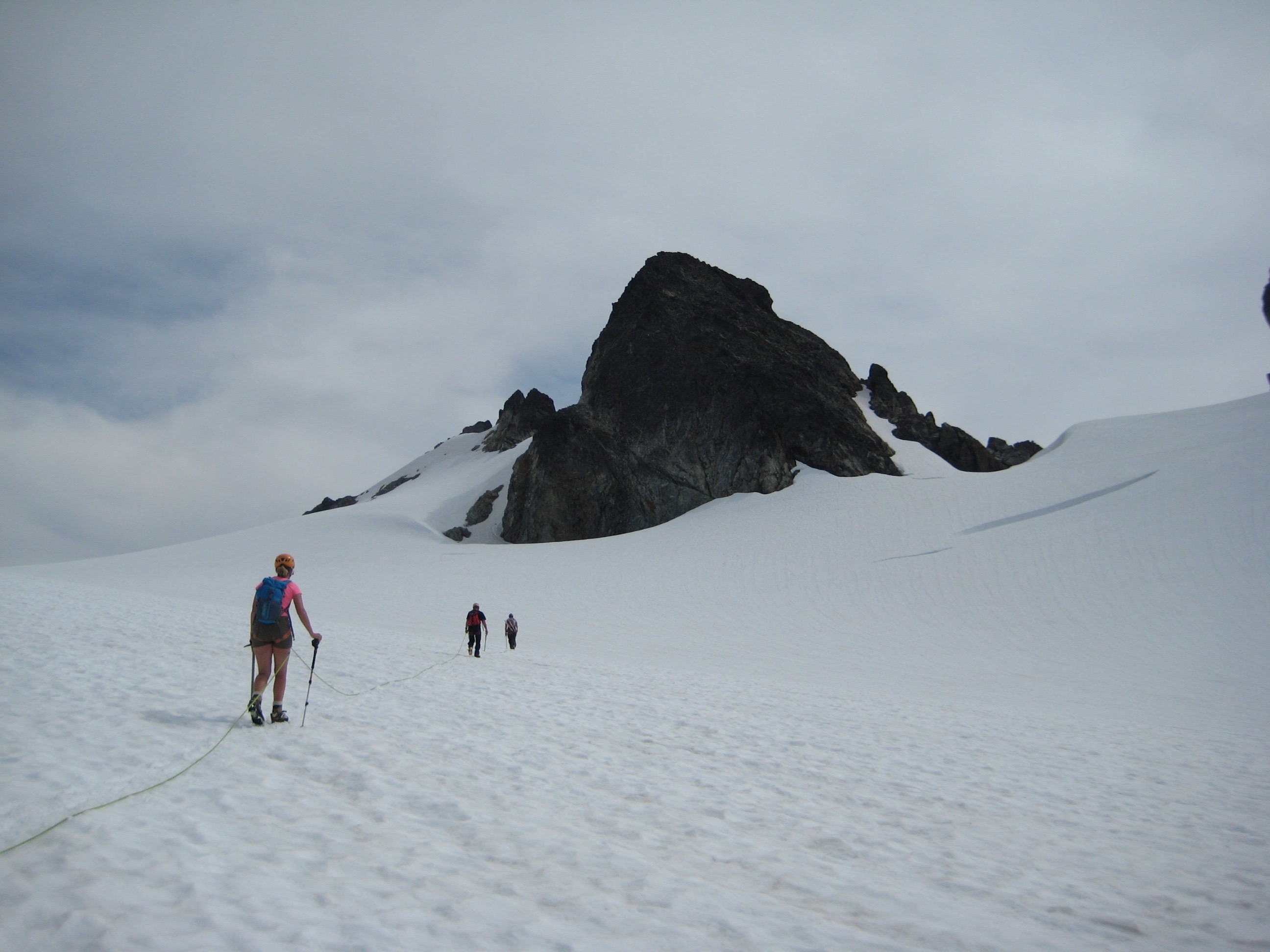 roped mountain climbers heading to the rocky summit of Old Guard Peak on the Ptarmigan Traverse