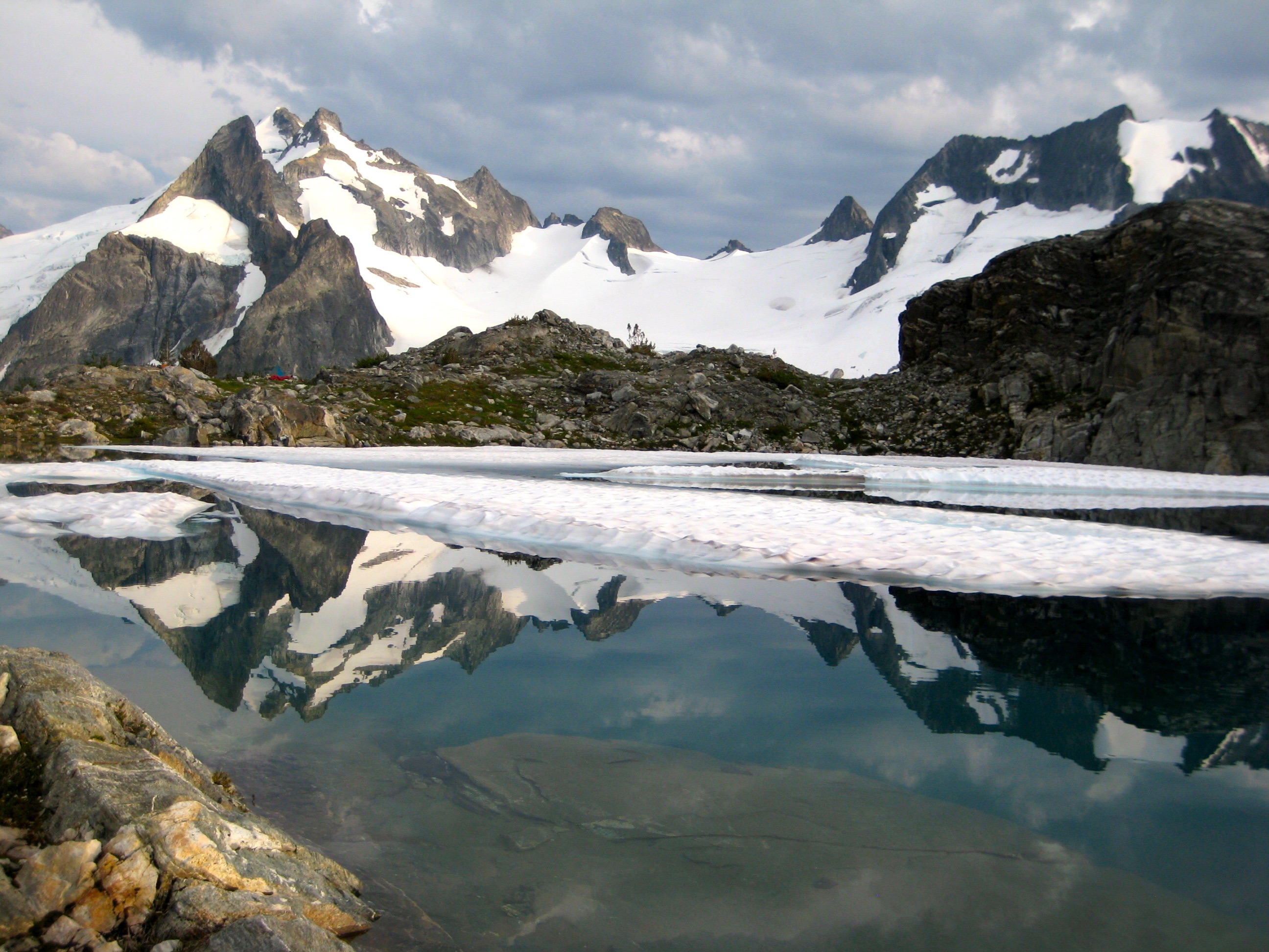 Dome Peak and Dana Glacier are reflected in White Rock Lake on the Ptarmingan Traverse